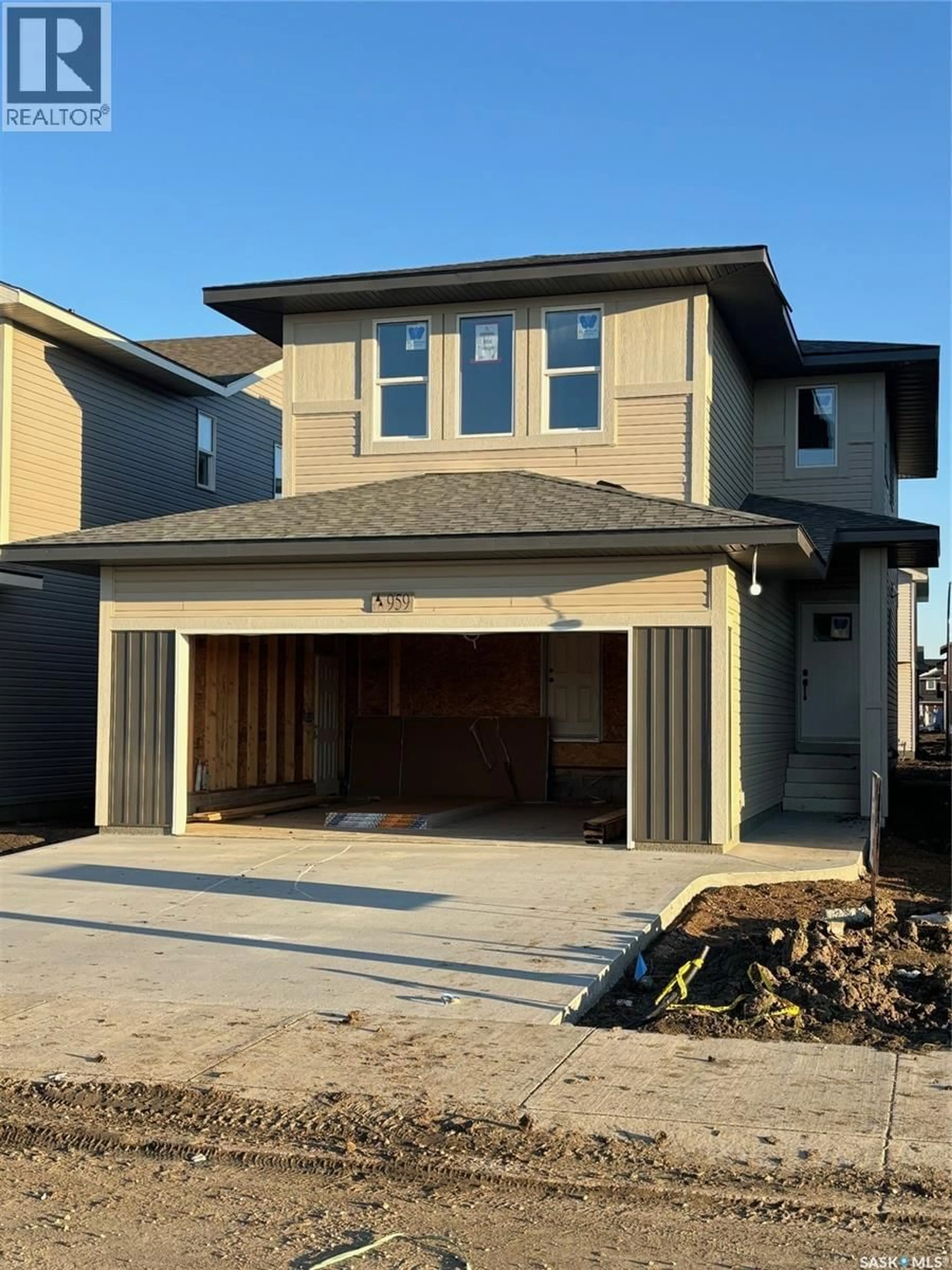 Home with vinyl exterior material, street for 959 TRAEGER MANOR, Saskatoon Saskatchewan S7W0L8