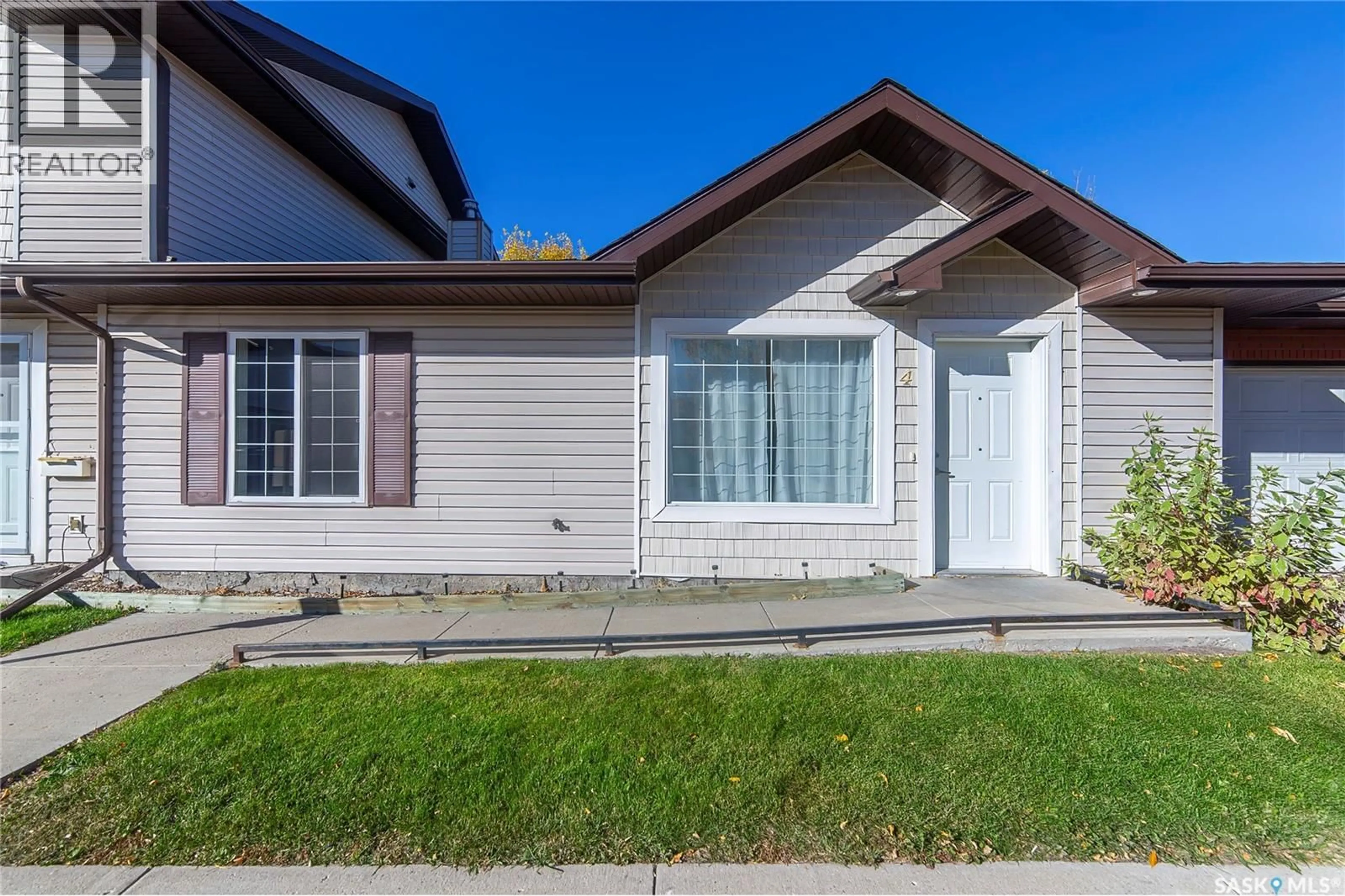 Home with vinyl exterior material, street for 4 135 KEEDWELL STREET, Saskatoon Saskatchewan S7W0A3