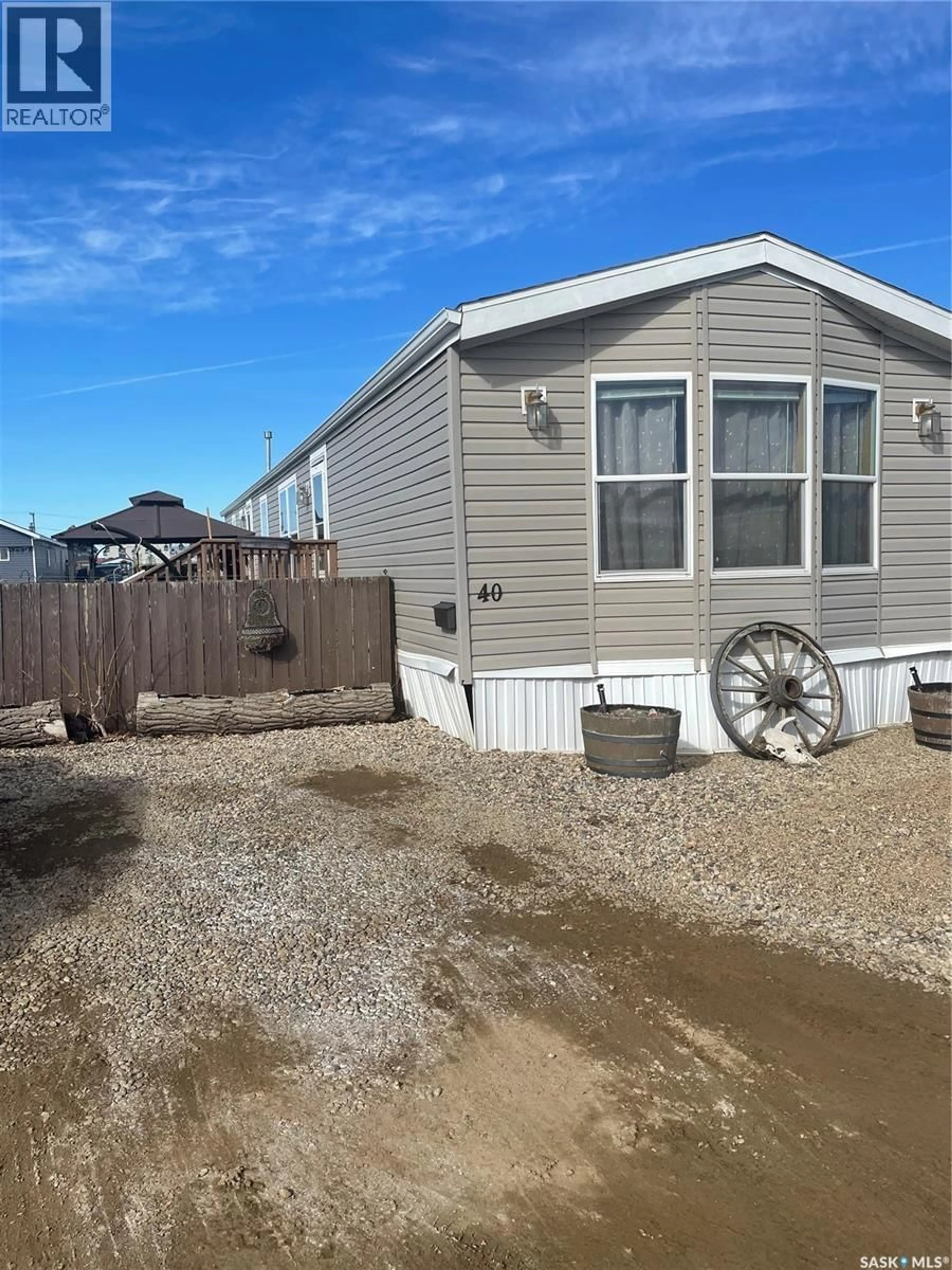 Home with vinyl exterior material, street for 106 - 40 1ST AVENUE, Weyburn Saskatchewan S4H2J1