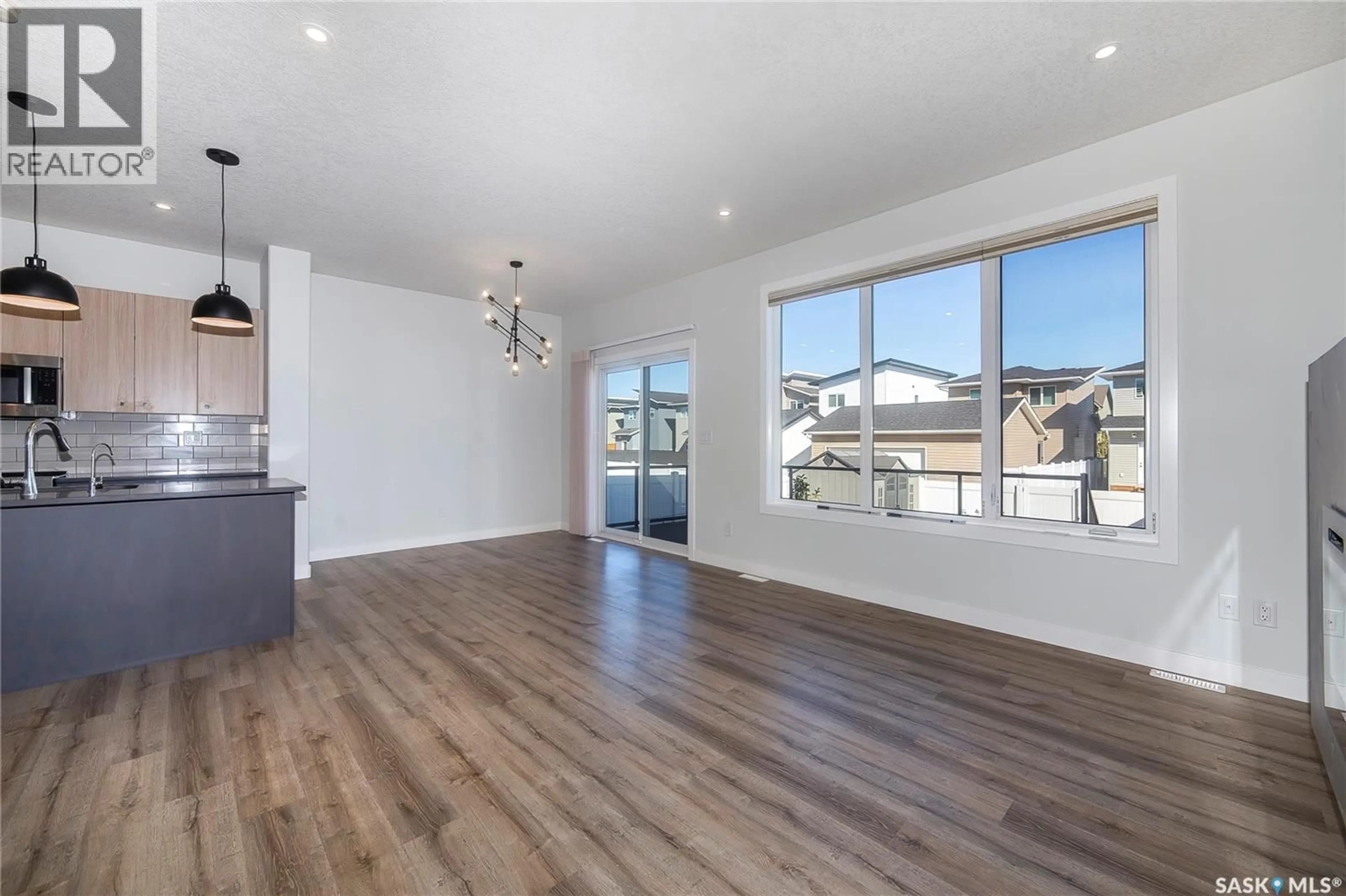 Open concept kitchen, wood/laminate floor for 259 PRASAD MANOR, Saskatoon Saskatchewan S7V1L4
