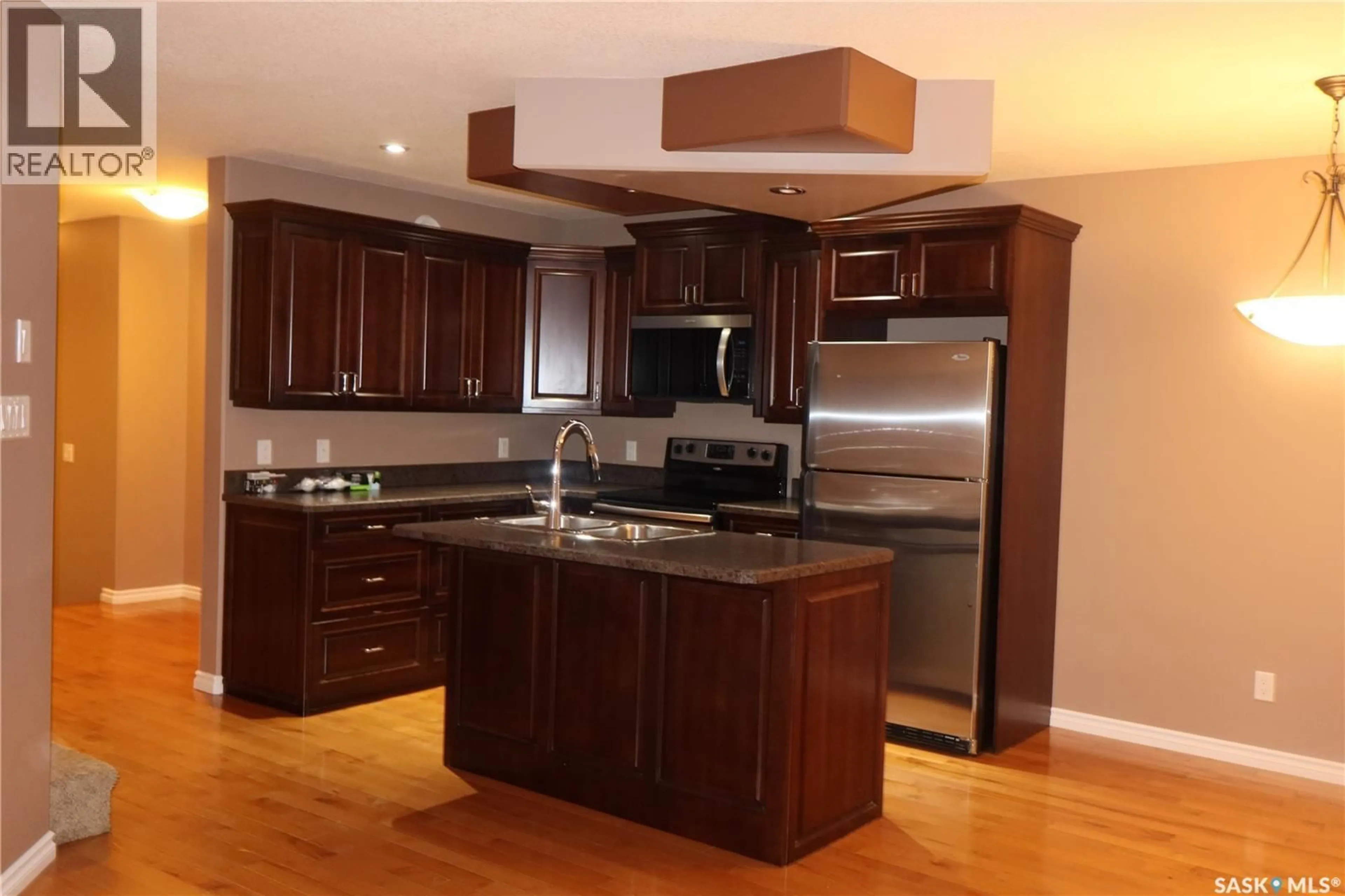 Open concept kitchen, wood/laminate floor for D2 - 33 WOOD LILY DRIVE, Moose Jaw Saskatchewan S6J1E4