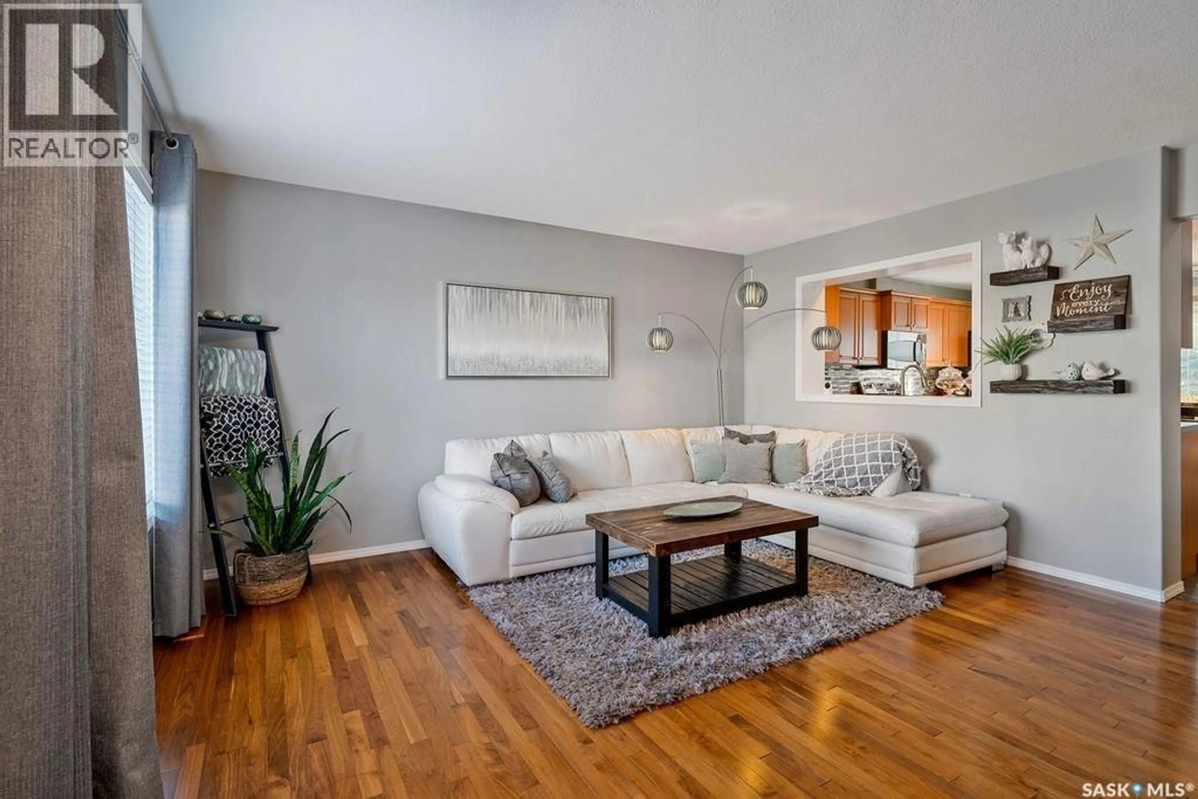 Living room with furniture, wood/laminate floor for 134 4601 CHILD AVENUE, Regina Saskatchewan S4X0A2