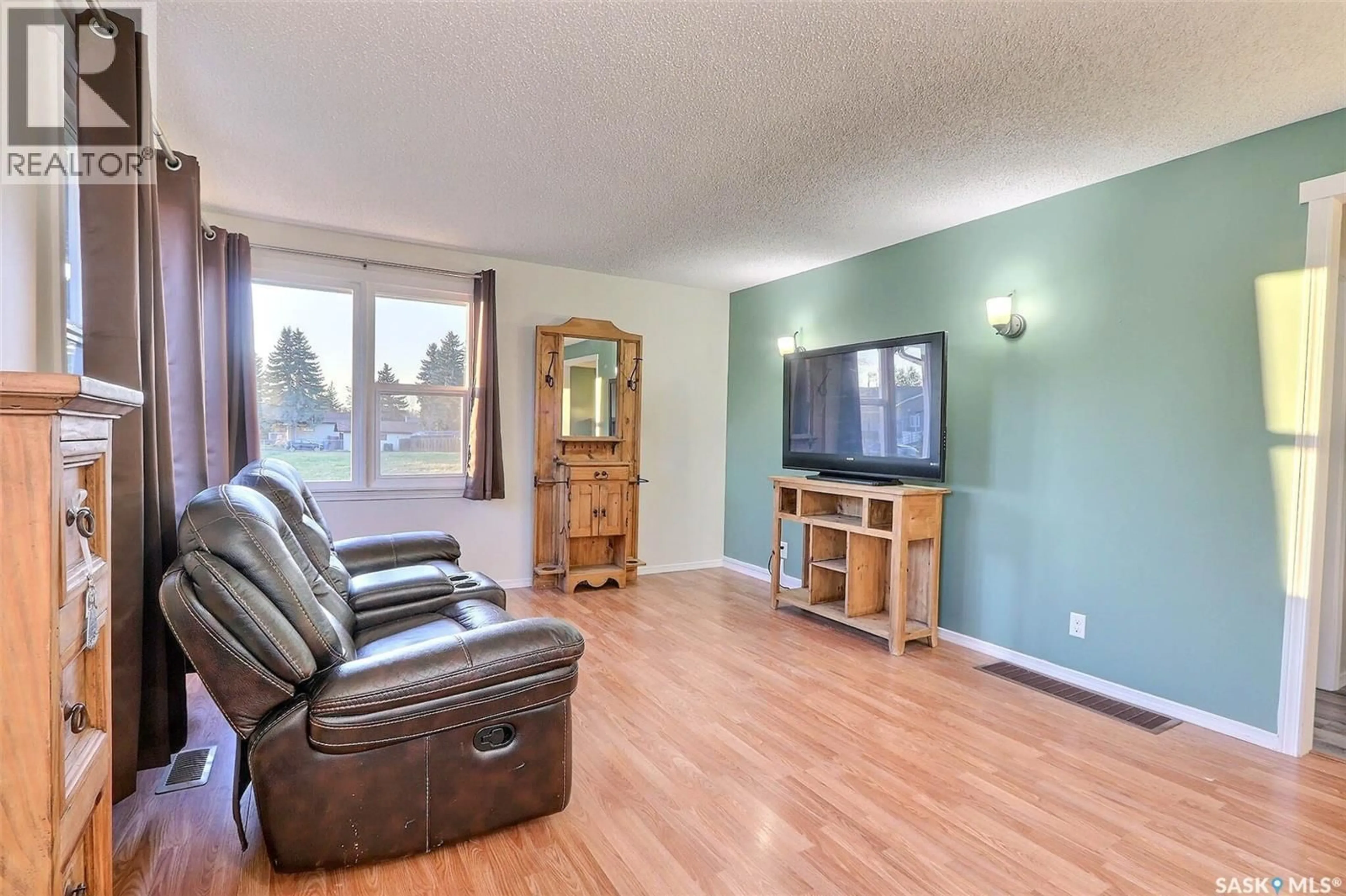 Living room with furniture, wood/laminate floor for 860 7TH STREET, Prince Albert Saskatchewan S6V0T2