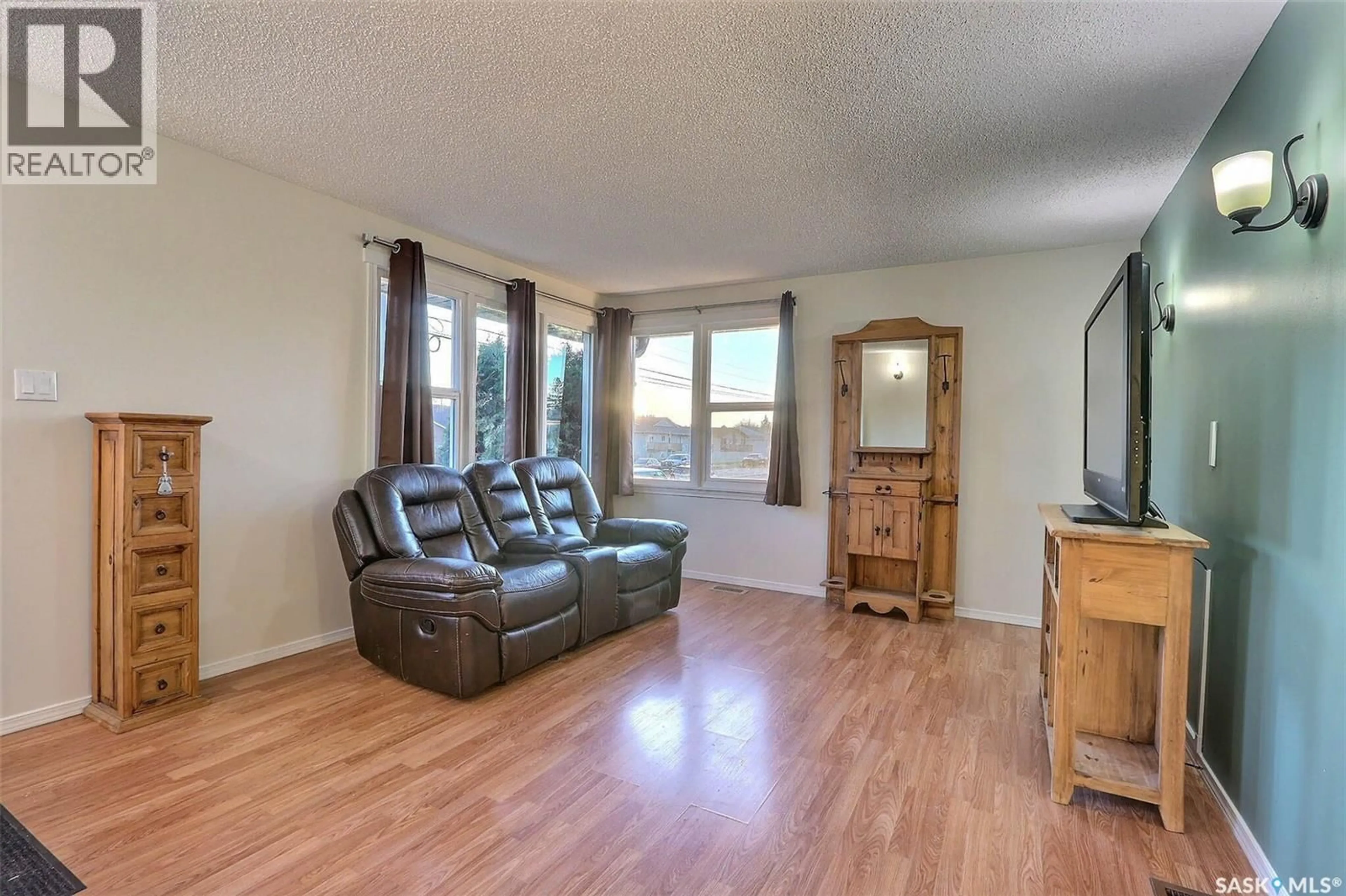Living room with furniture, wood/laminate floor for 860 7TH STREET, Prince Albert Saskatchewan S6V0T2