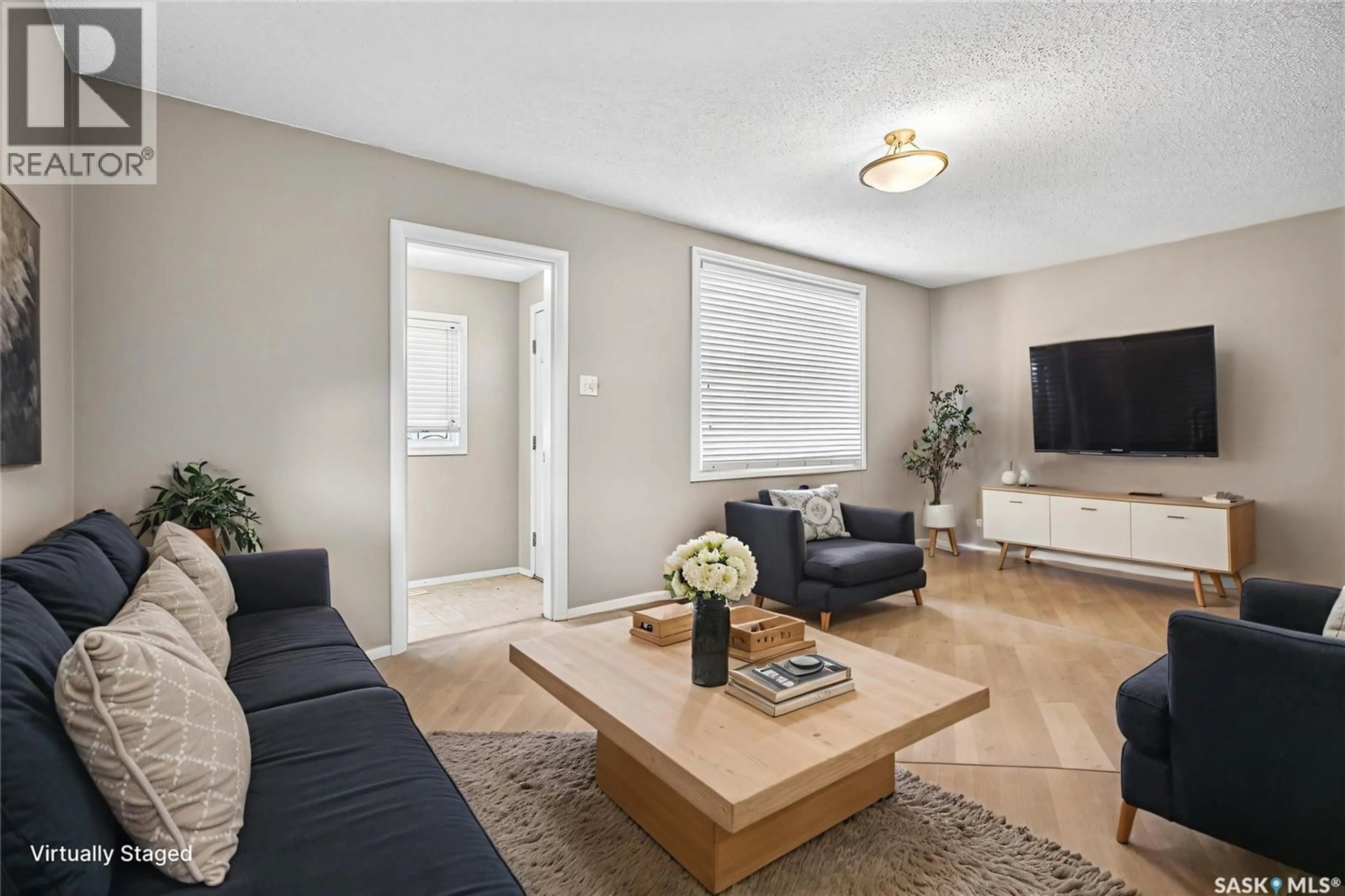 Living room with furniture, wood/laminate floor for 1020 9TH AVENUE, Moose Jaw Saskatchewan S6H4J5