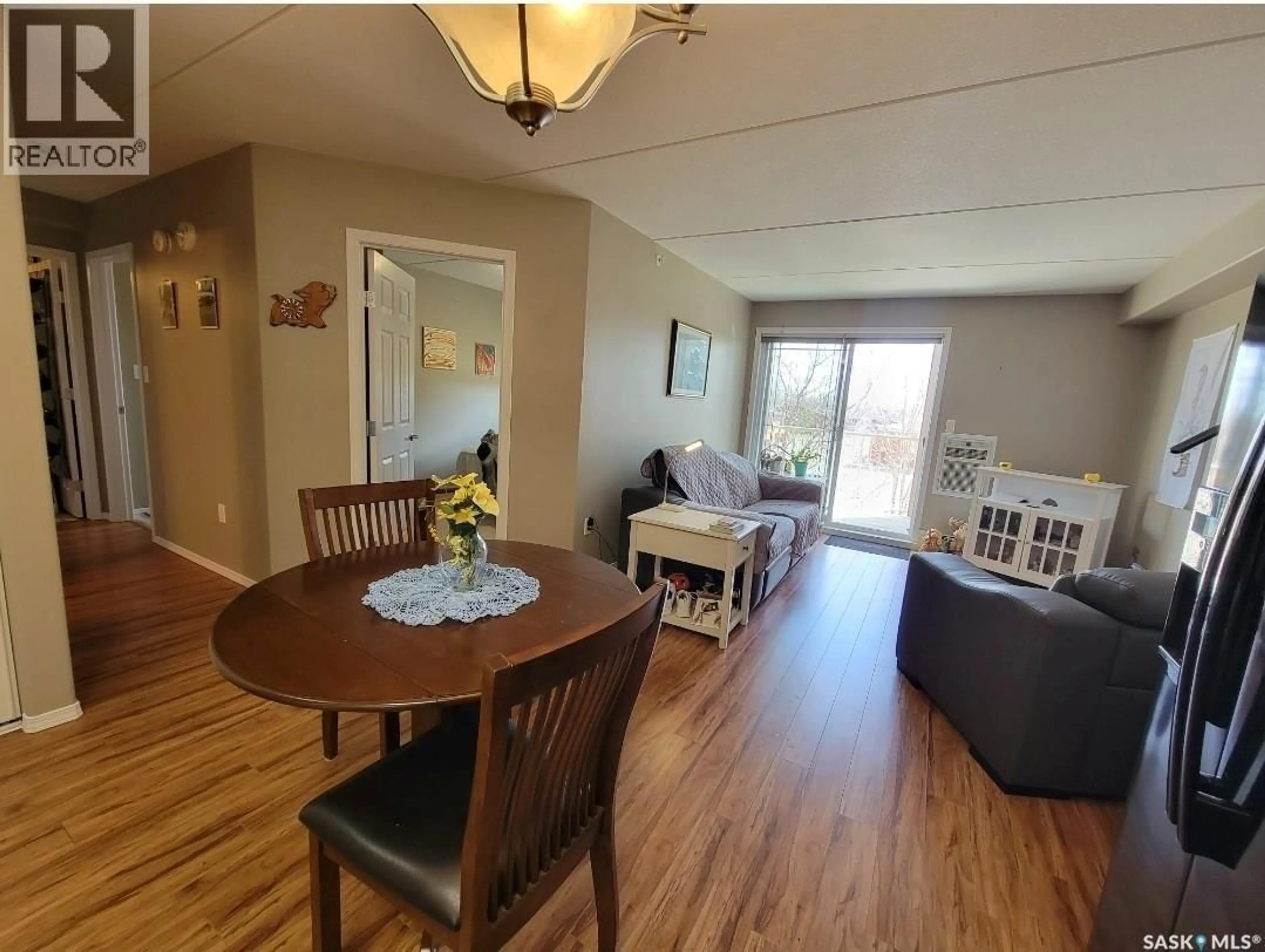 Living room with furniture, wood/laminate floor for 201 2 18TH STREET, Battleford Saskatchewan S0M0E0