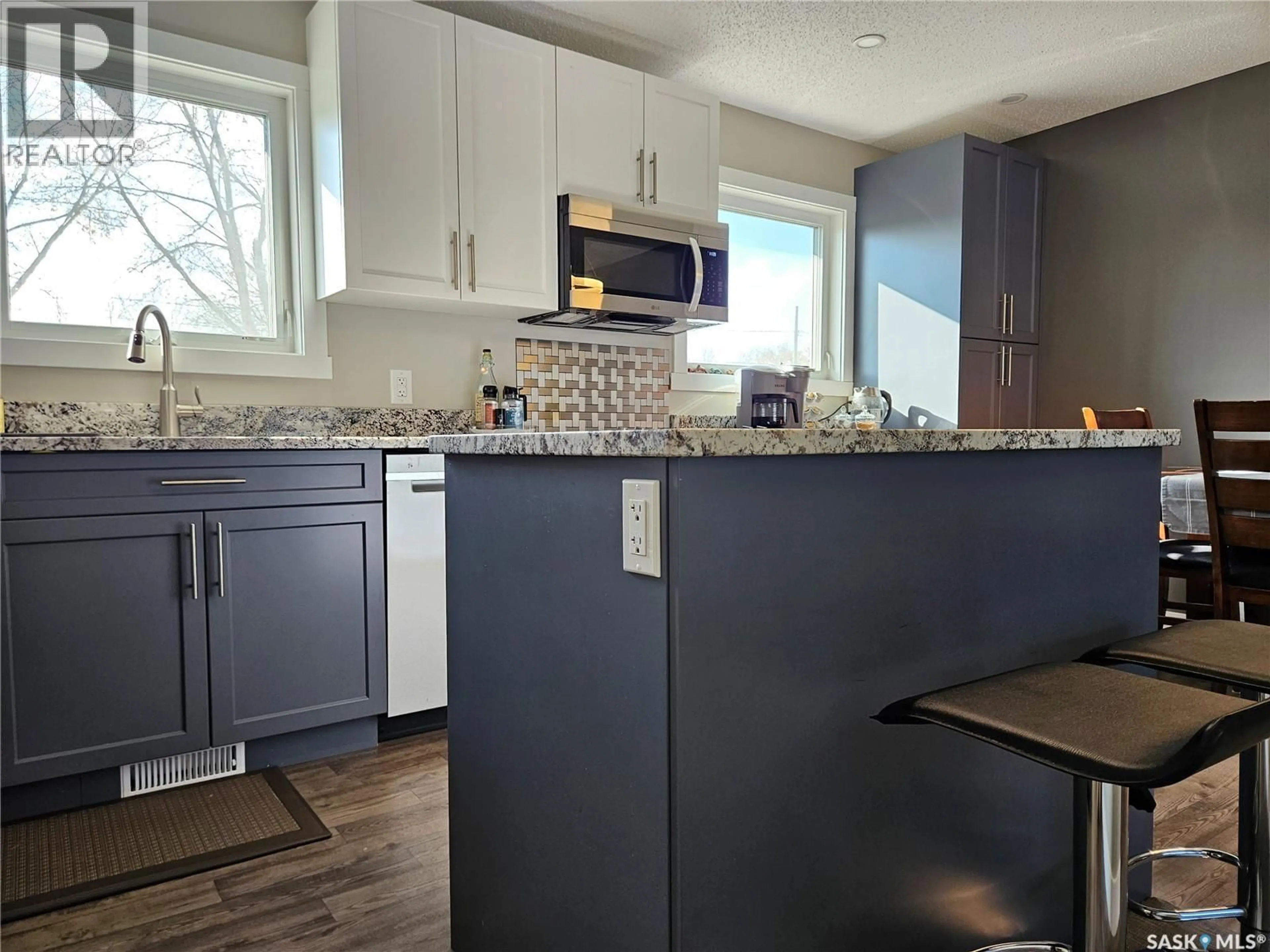 Open concept kitchen, wood/laminate floor for 1010 101ST AVENUE, Tisdale Saskatchewan S0E1T0