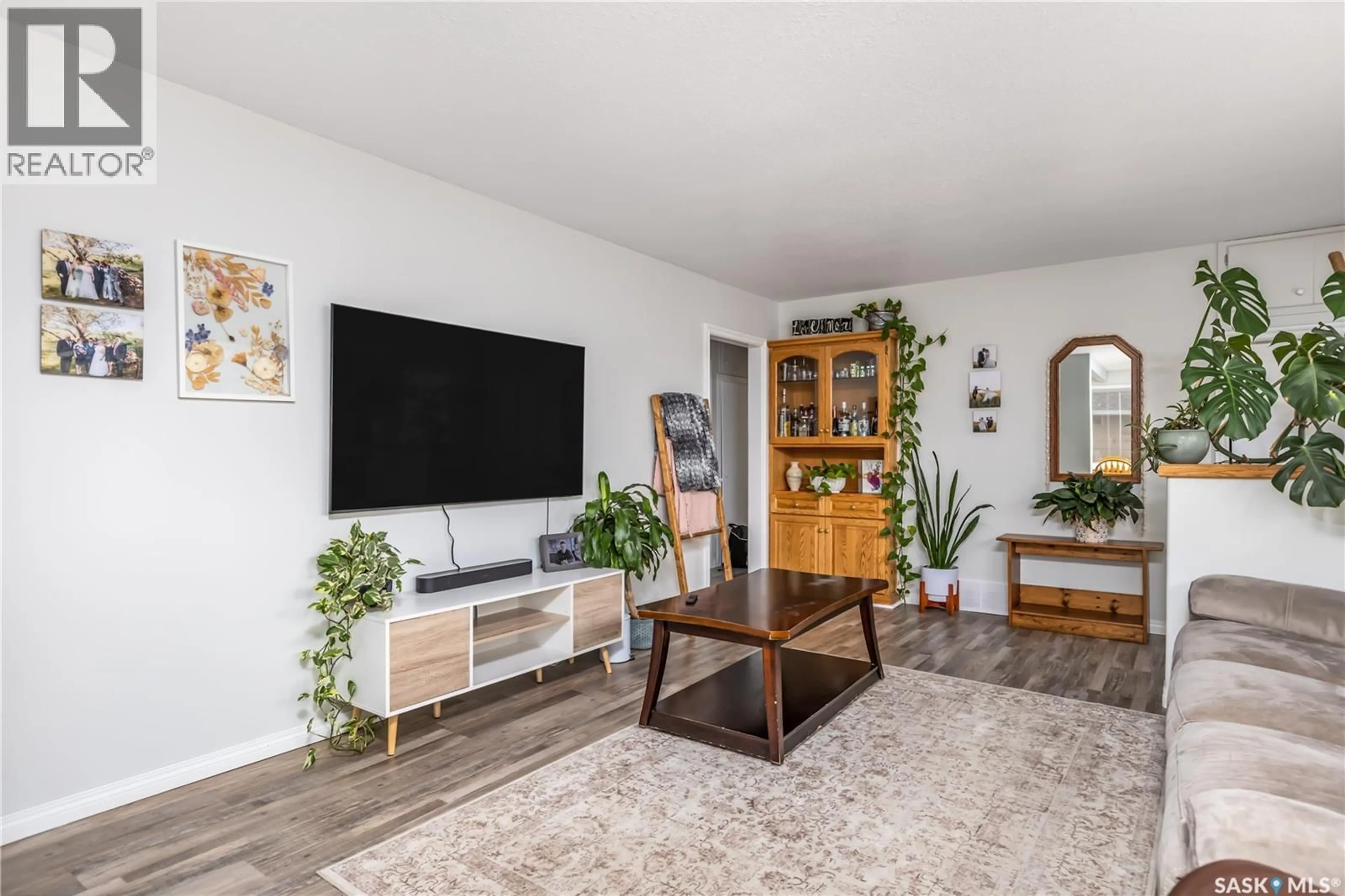 Living room with furniture, wood/laminate floor for 413 BEMISTER AVENUE, Melfort Saskatchewan S0E1A0