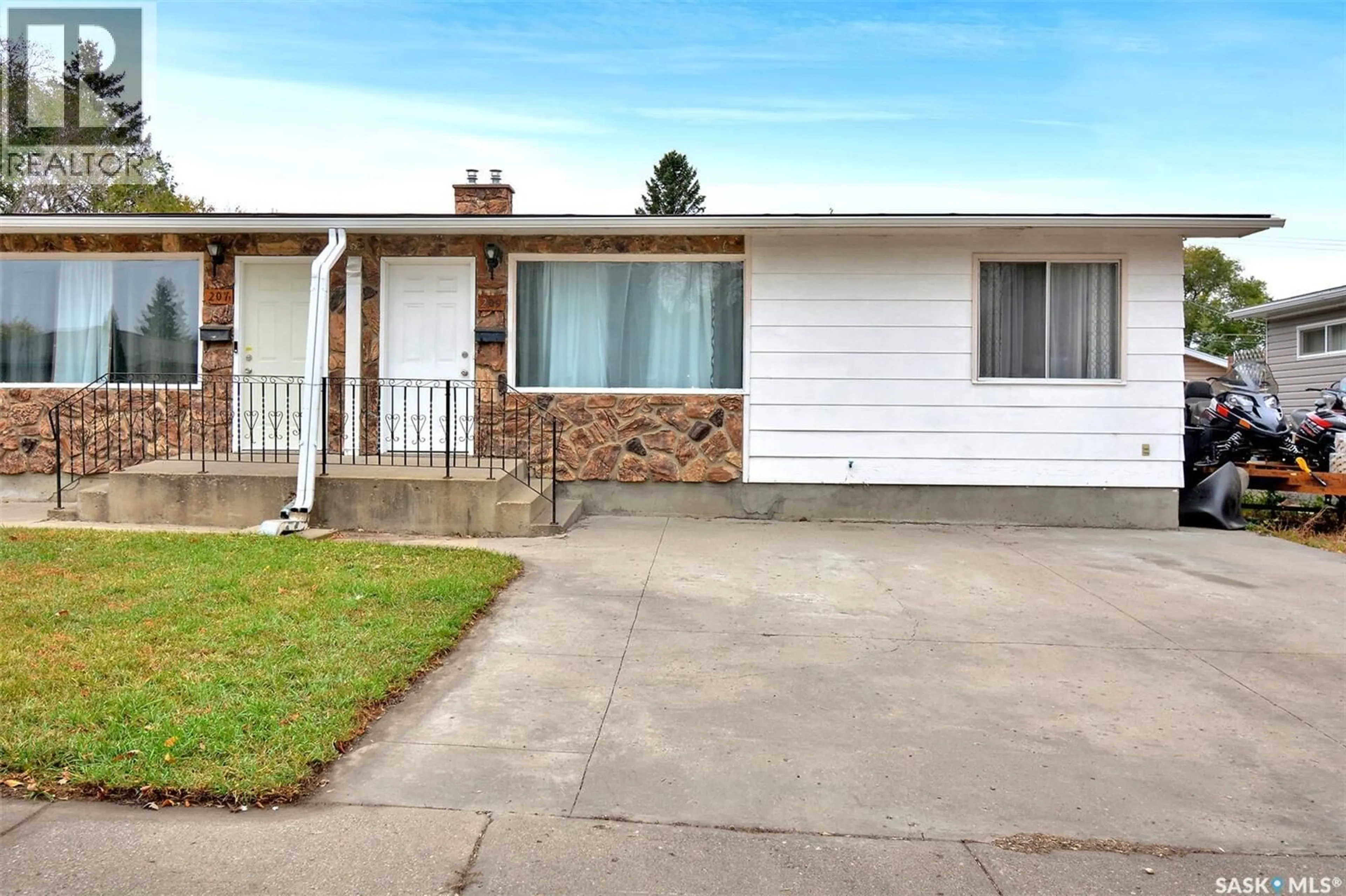 Home with vinyl exterior material, street for 207-209 S AVENUE N, Saskatoon Saskatchewan S7L2Z7