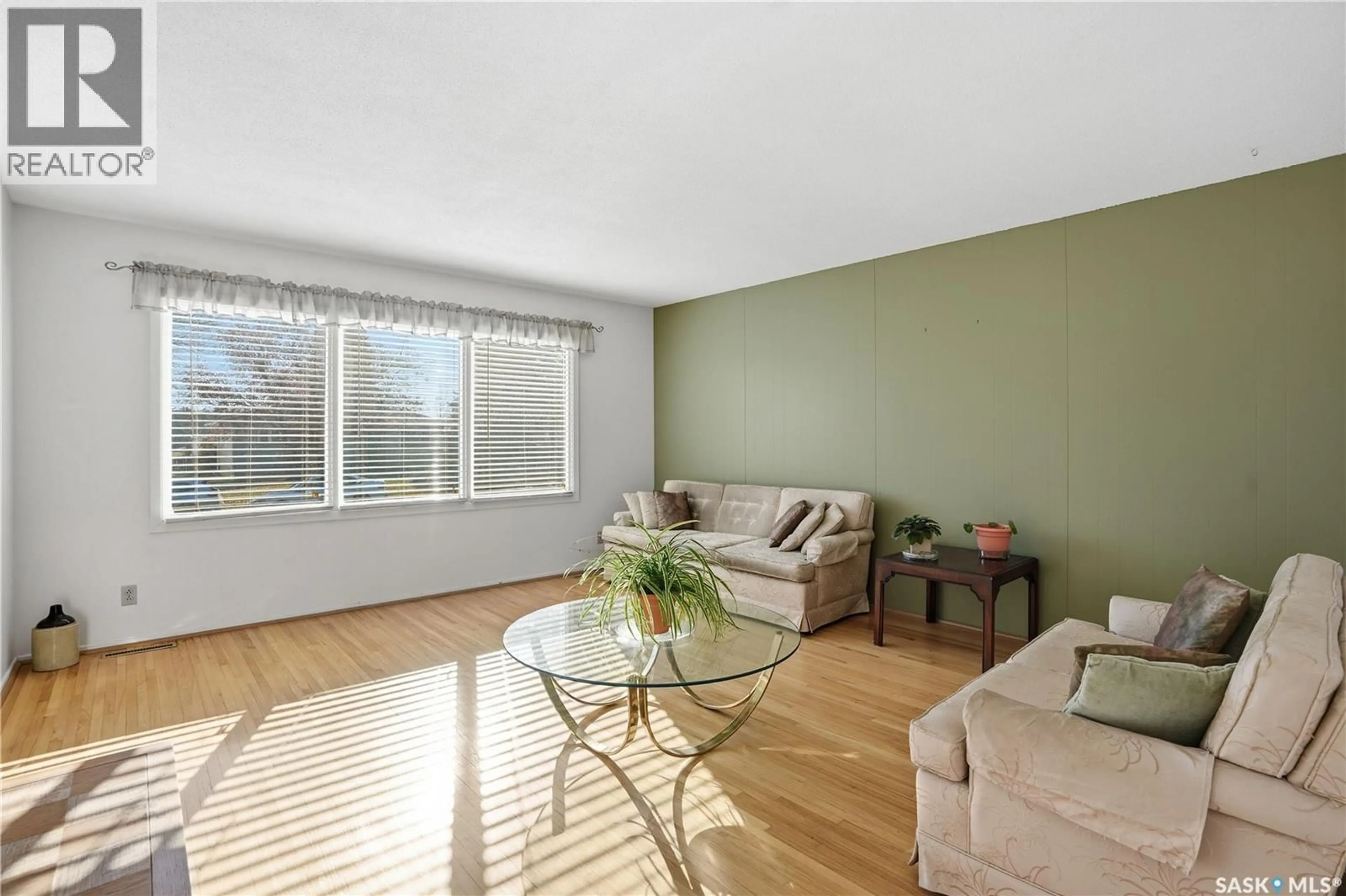 Living room with furniture, wood/laminate floor for 91 HOWELL AVENUE, Saskatoon Saskatchewan S7L3S9