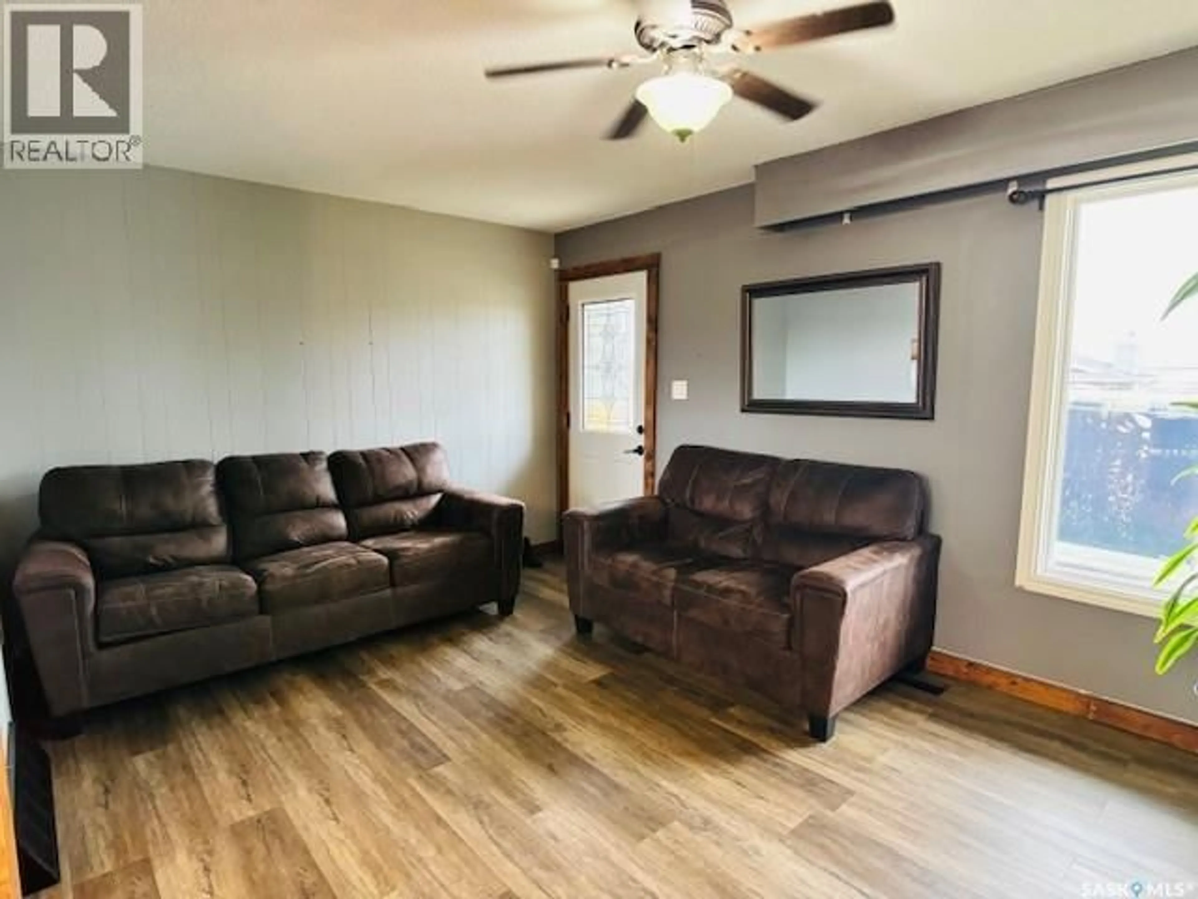 Living room with furniture, wood/laminate floor for 112 FRASER AVENUE, Oxbow Saskatchewan S0C2B0