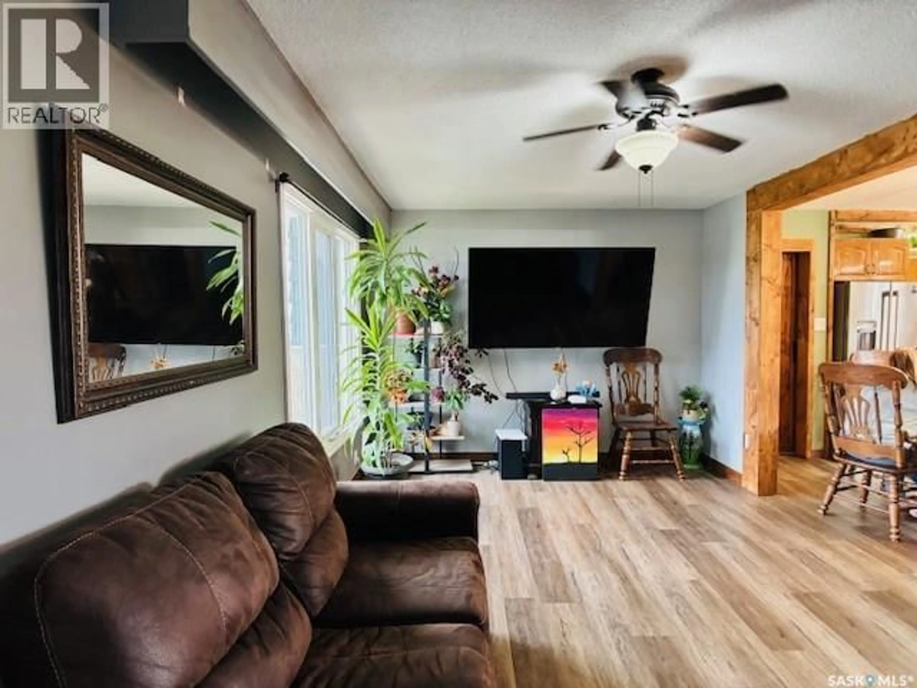 Living room with furniture, wood/laminate floor for 112 FRASER AVENUE, Oxbow Saskatchewan S0C2B0
