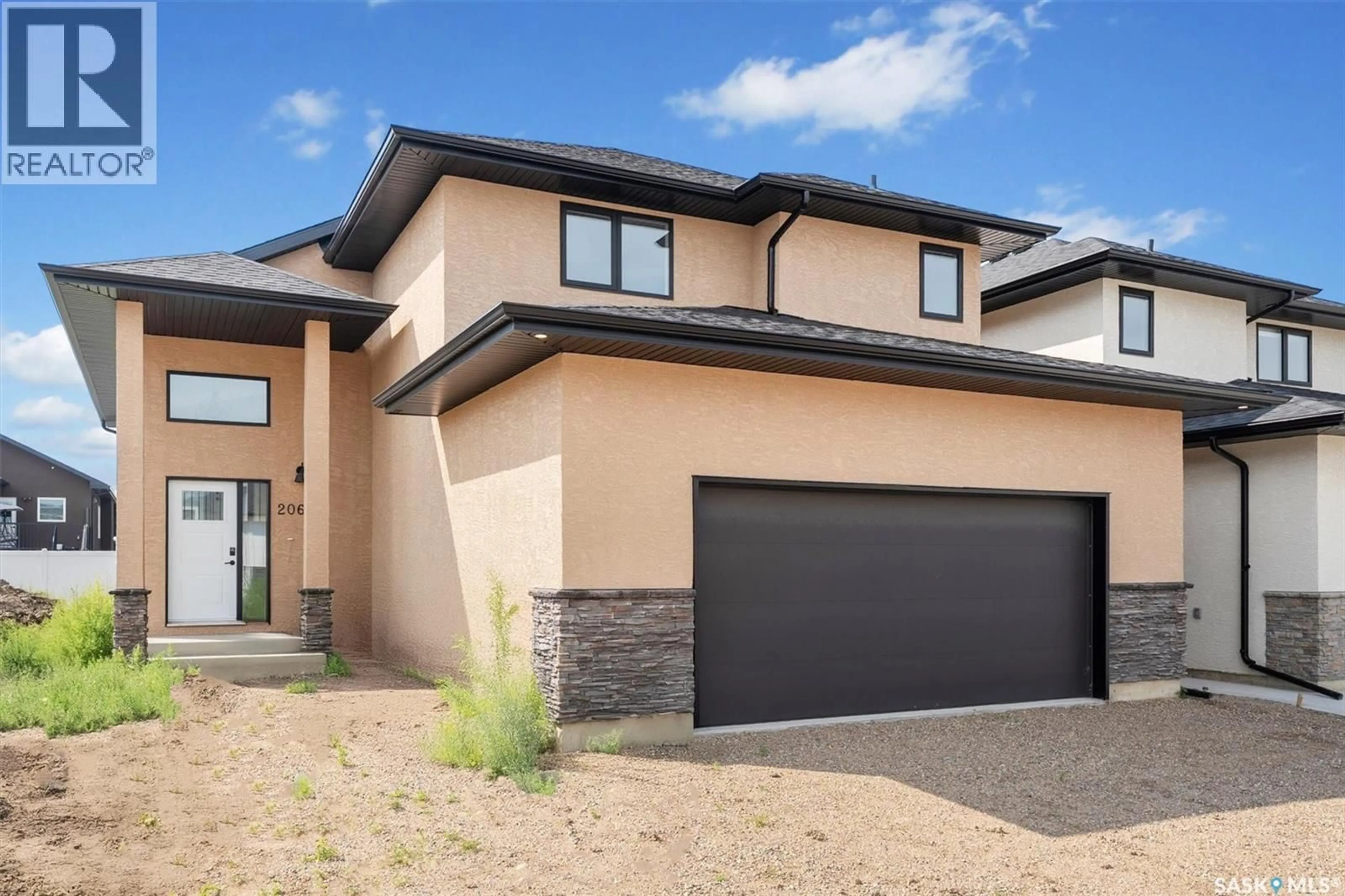 Home with brick exterior material, street for 206 FLYNN BEND, Saskatoon Saskatchewan S7V1R9