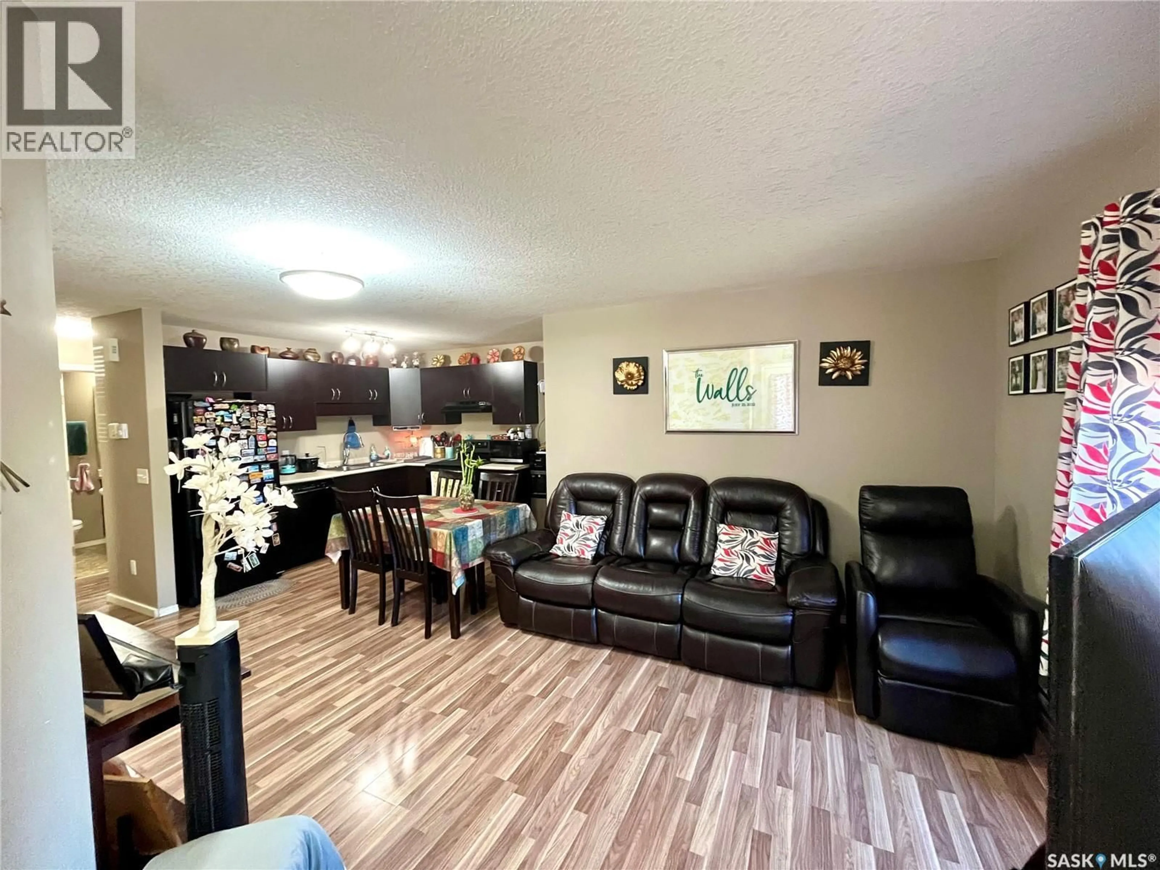 Living room with furniture, wood/laminate floor for 700 - 502 BATTLEFORD TRAIL, Swift Current Saskatchewan S9H4V9