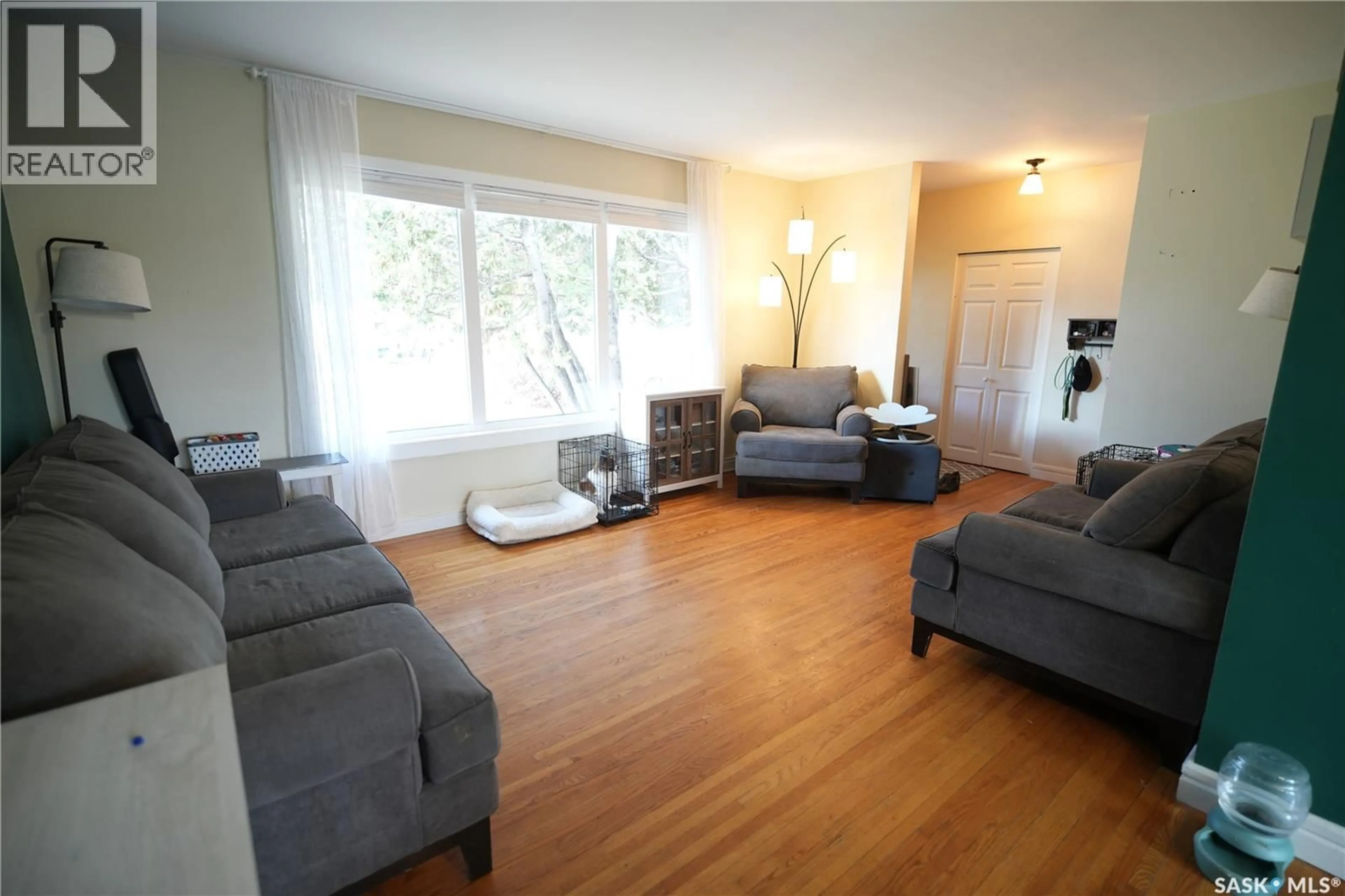 Living room with furniture, wood/laminate floor for 2337 MCKINNON AVENUE, Saskatoon Saskatchewan S7J1N7
