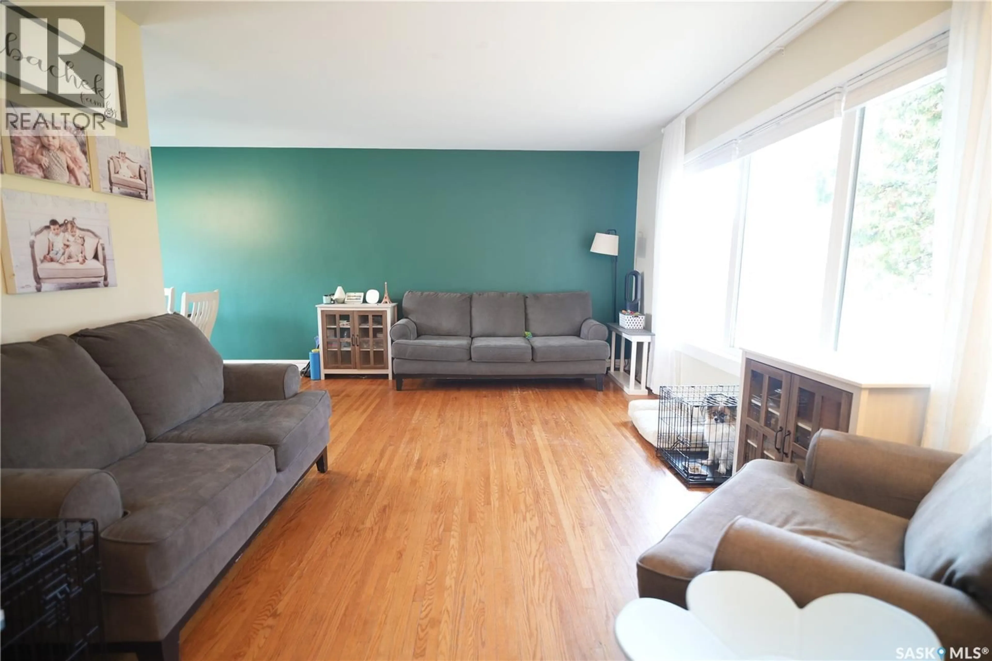 Living room with furniture, wood/laminate floor for 2337 MCKINNON AVENUE, Saskatoon Saskatchewan S7J1N7