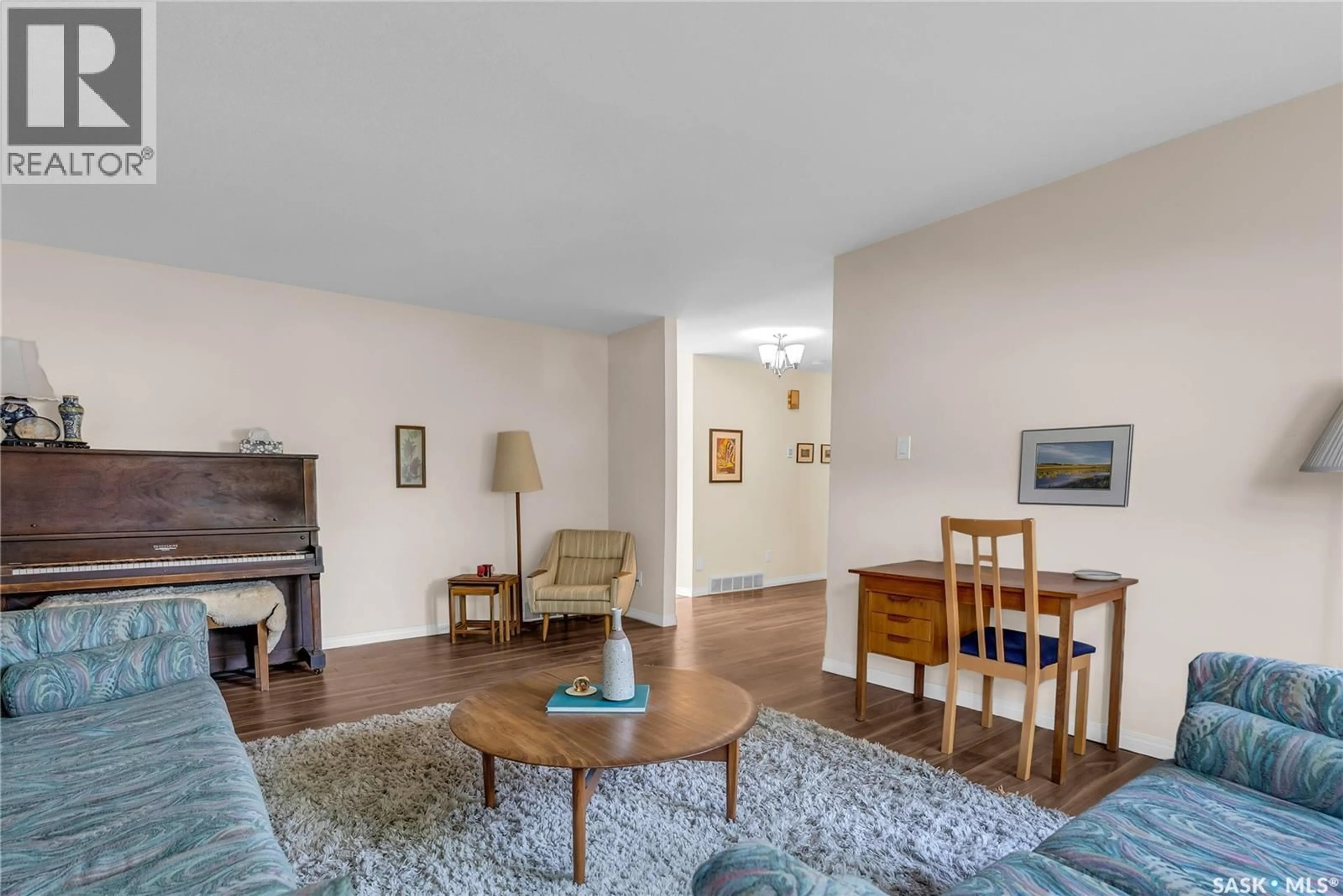 Living room with furniture, wood/laminate floor for 54 BRITNELL CRESCENT, Saskatoon Saskatchewan S7H3X8