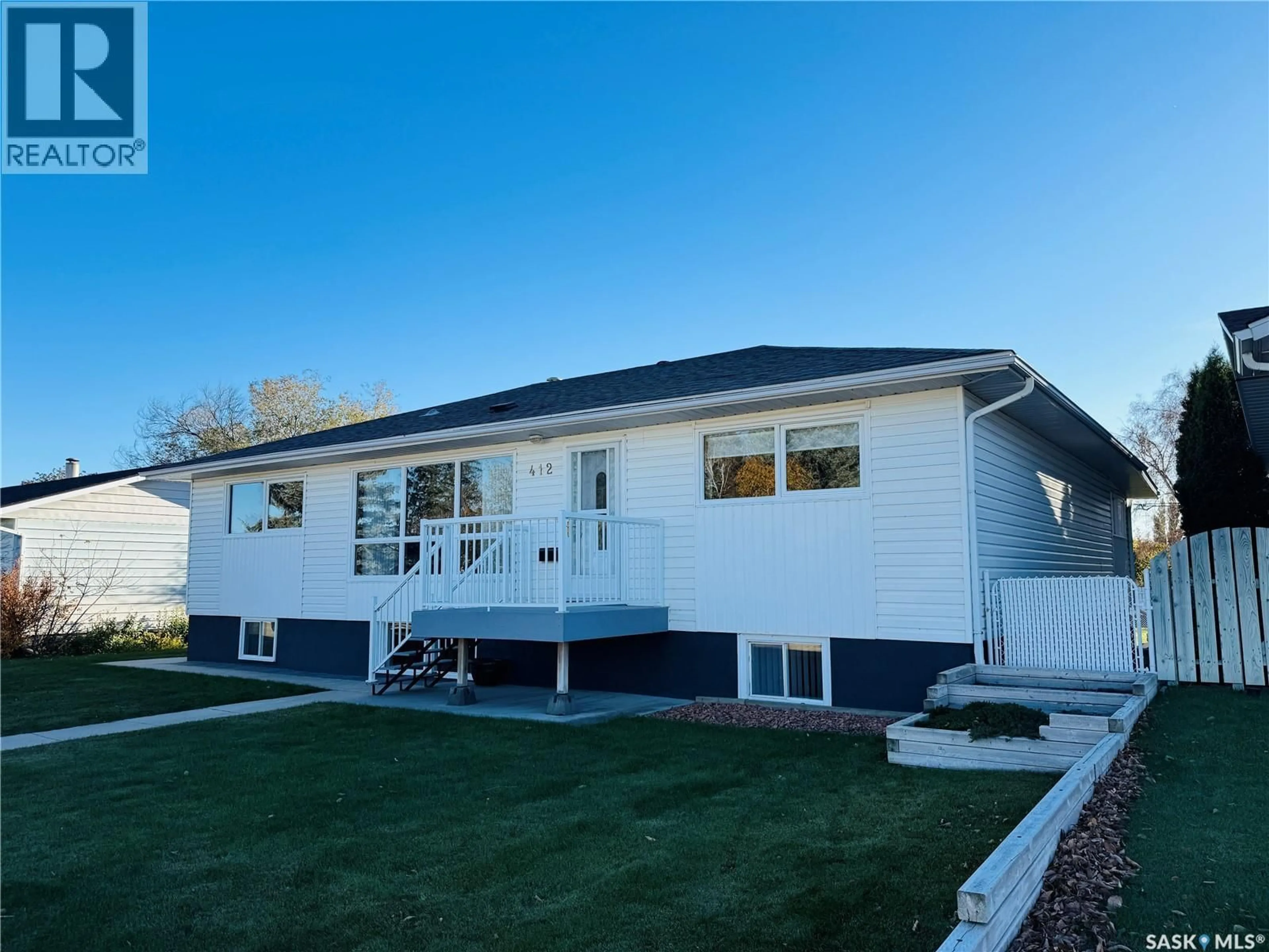 Home with vinyl exterior material, street for 412 7TH AVENUE, Biggar Saskatchewan S0K0M0