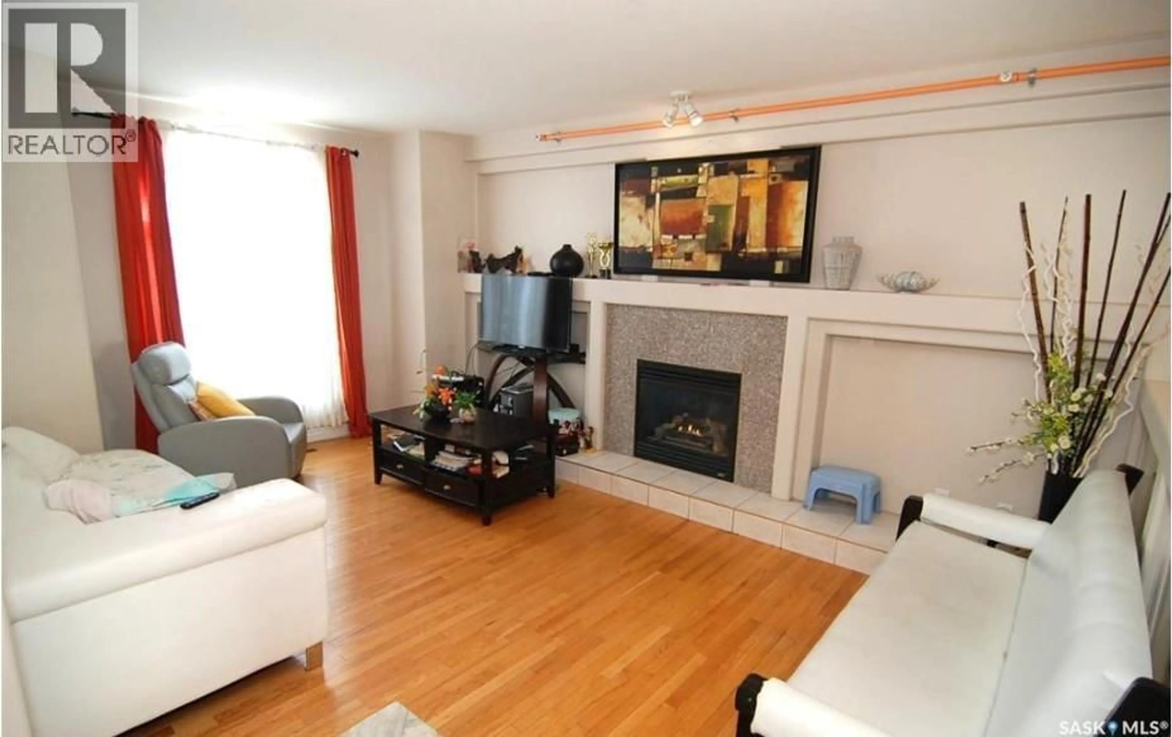 Living room with furniture, wood/laminate floor for 2915 37TH STREET, Saskatoon Saskatchewan S7L7H8