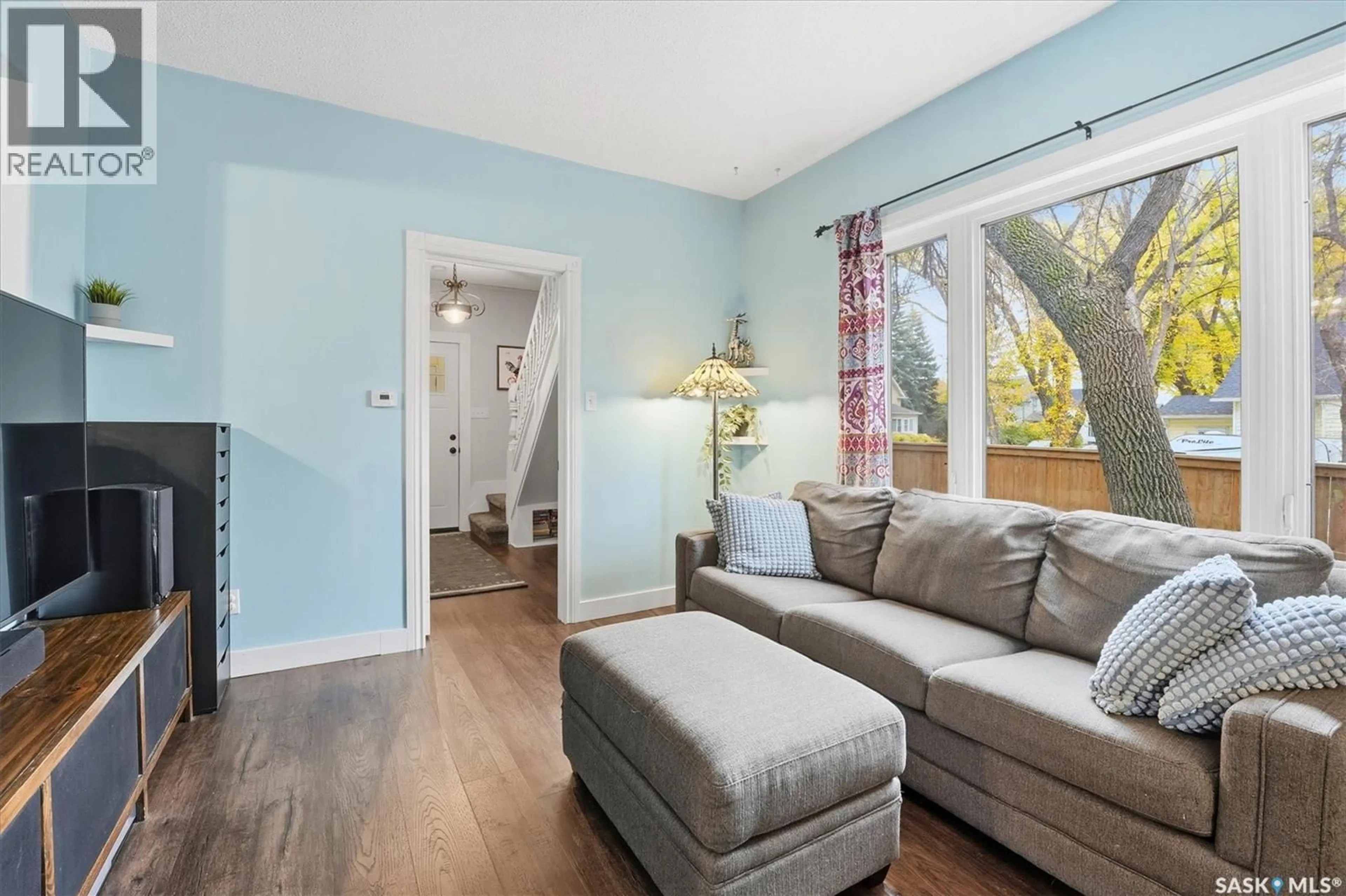 Living room with furniture, wood/laminate floor for 201 28TH STREET, Saskatoon Saskatchewan S7L0K4