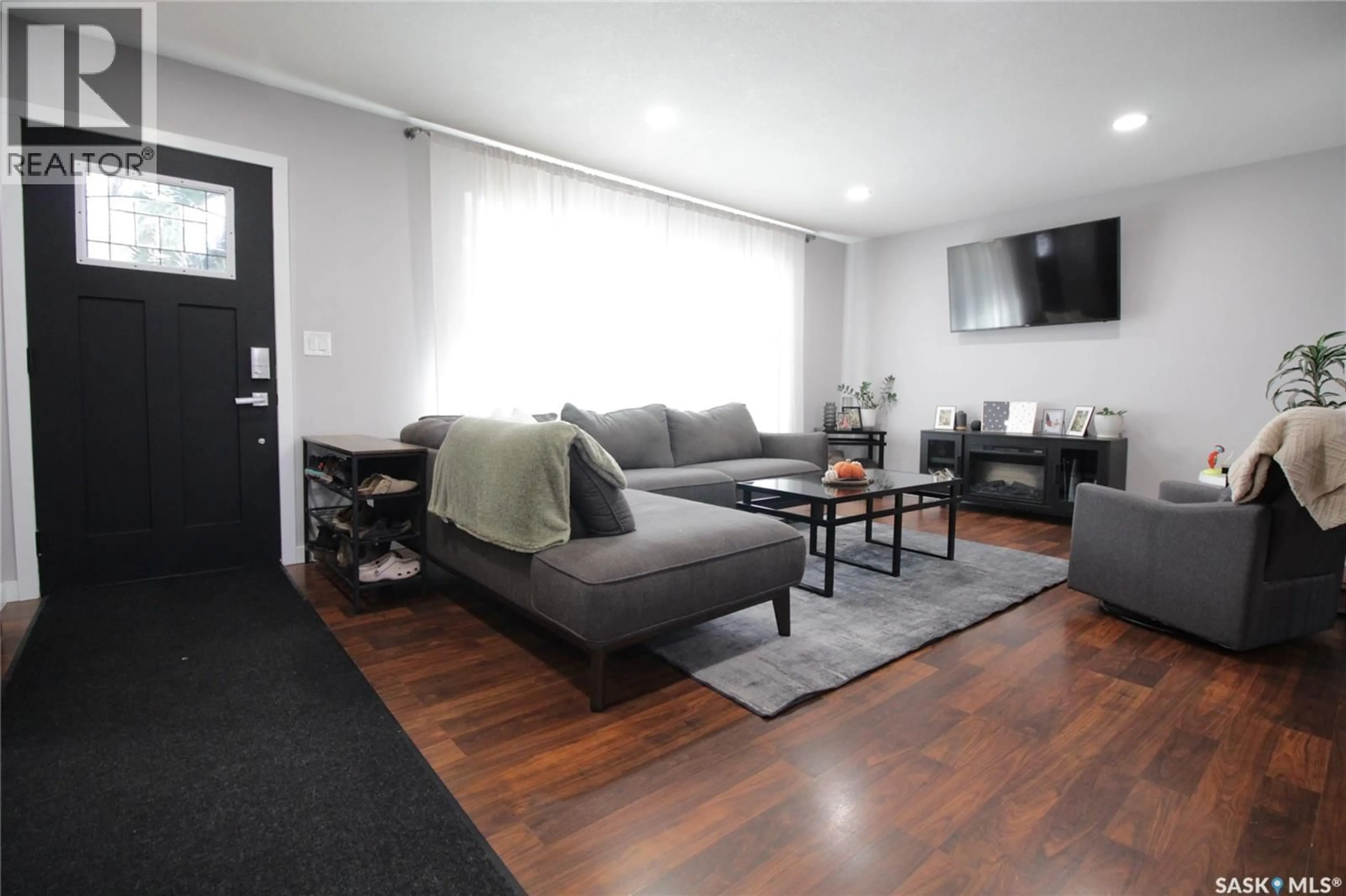 Living room with furniture, wood/laminate floor for 916 MOOSE STREET, Moosomin Saskatchewan S0G3N0