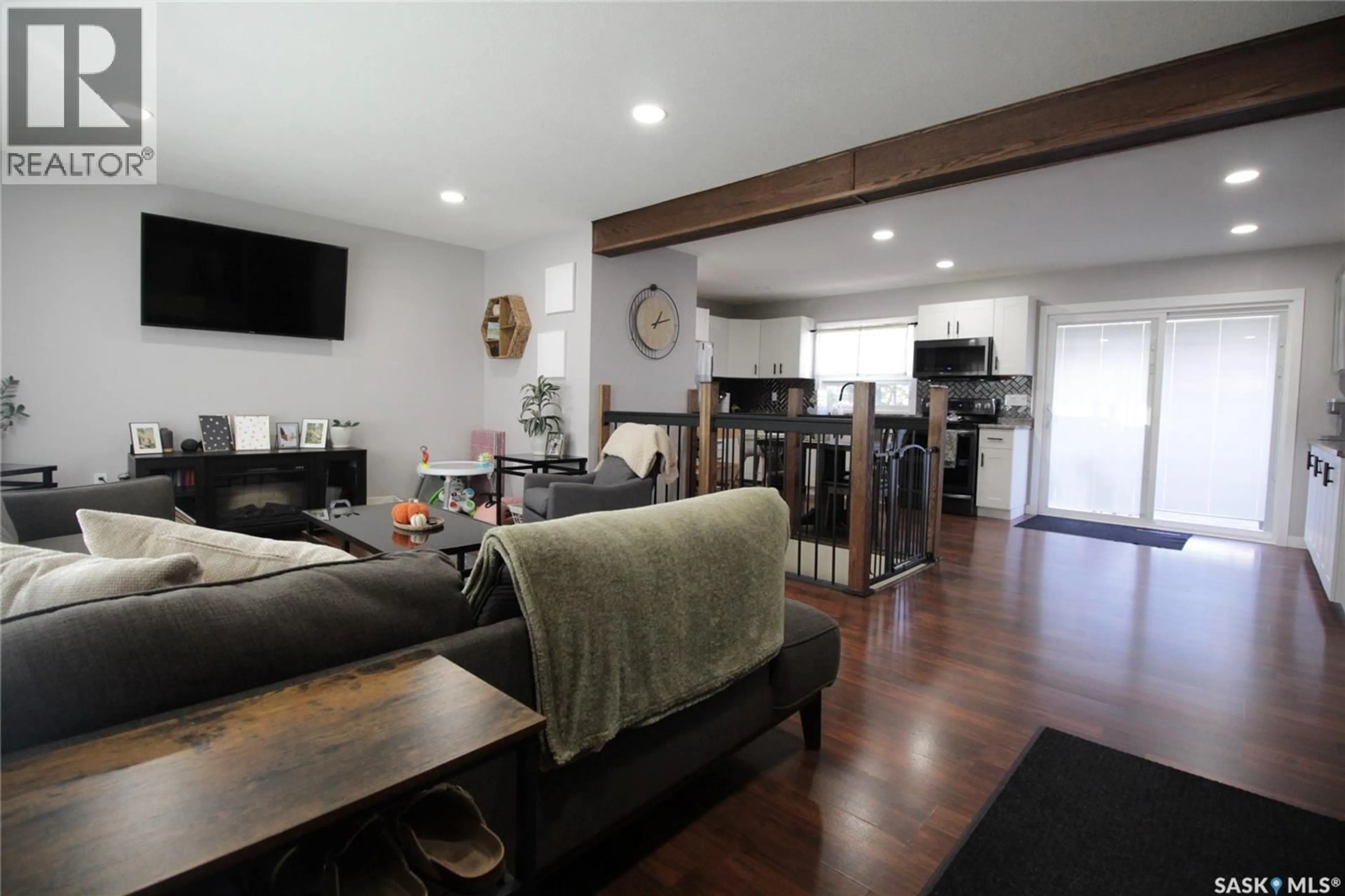 Living room with furniture, wood/laminate floor for 916 MOOSE STREET, Moosomin Saskatchewan S0G3N0