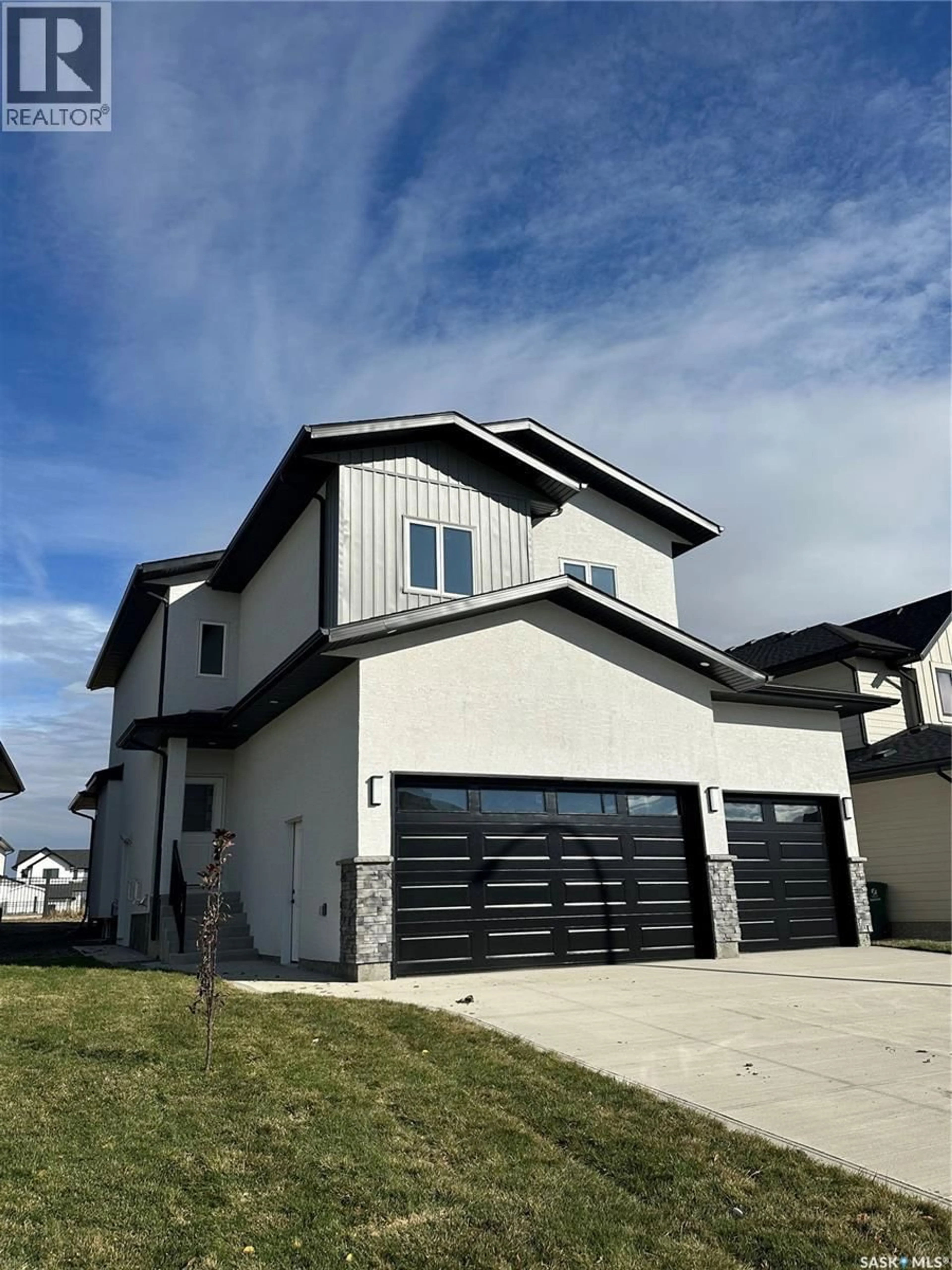 Home with vinyl exterior material, street for 147 WOOLF BEND, Saskatoon Saskatchewan S7W0L6