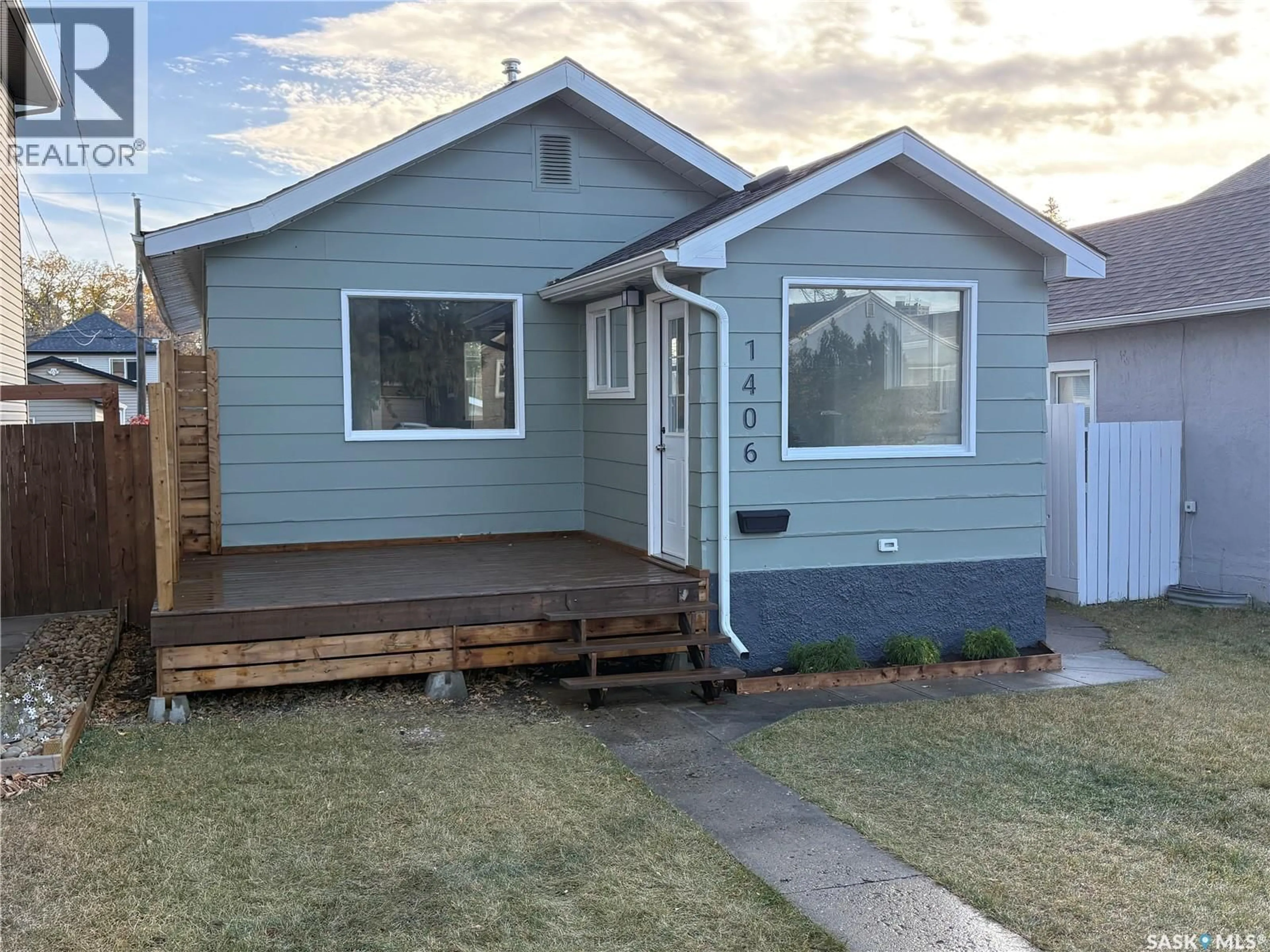 Home with vinyl exterior material, street for 1406 6TH AVENUE, Saskatoon Saskatchewan S7K2T8