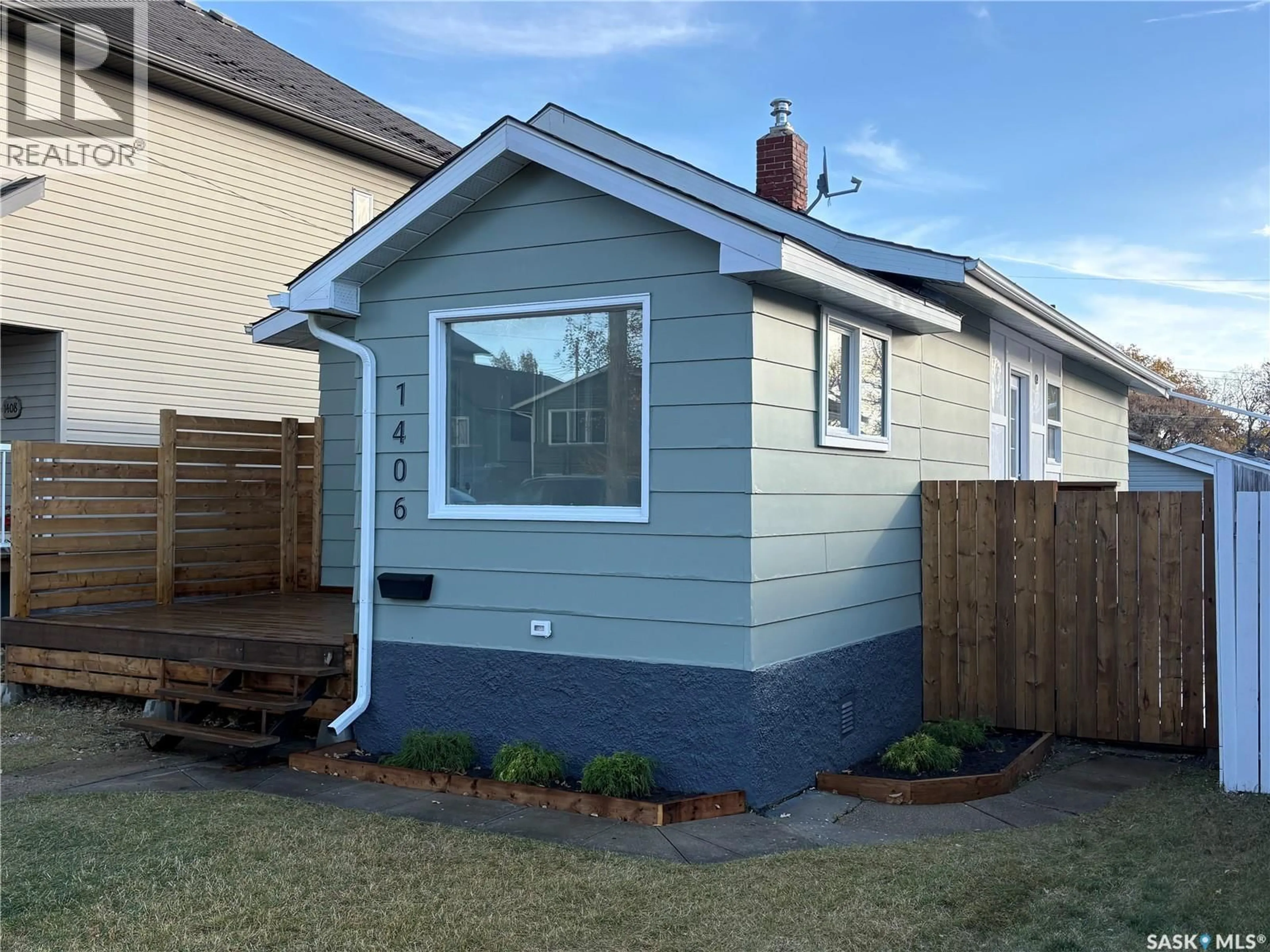 Home with vinyl exterior material, street for 1406 6TH AVENUE, Saskatoon Saskatchewan S7K2T8