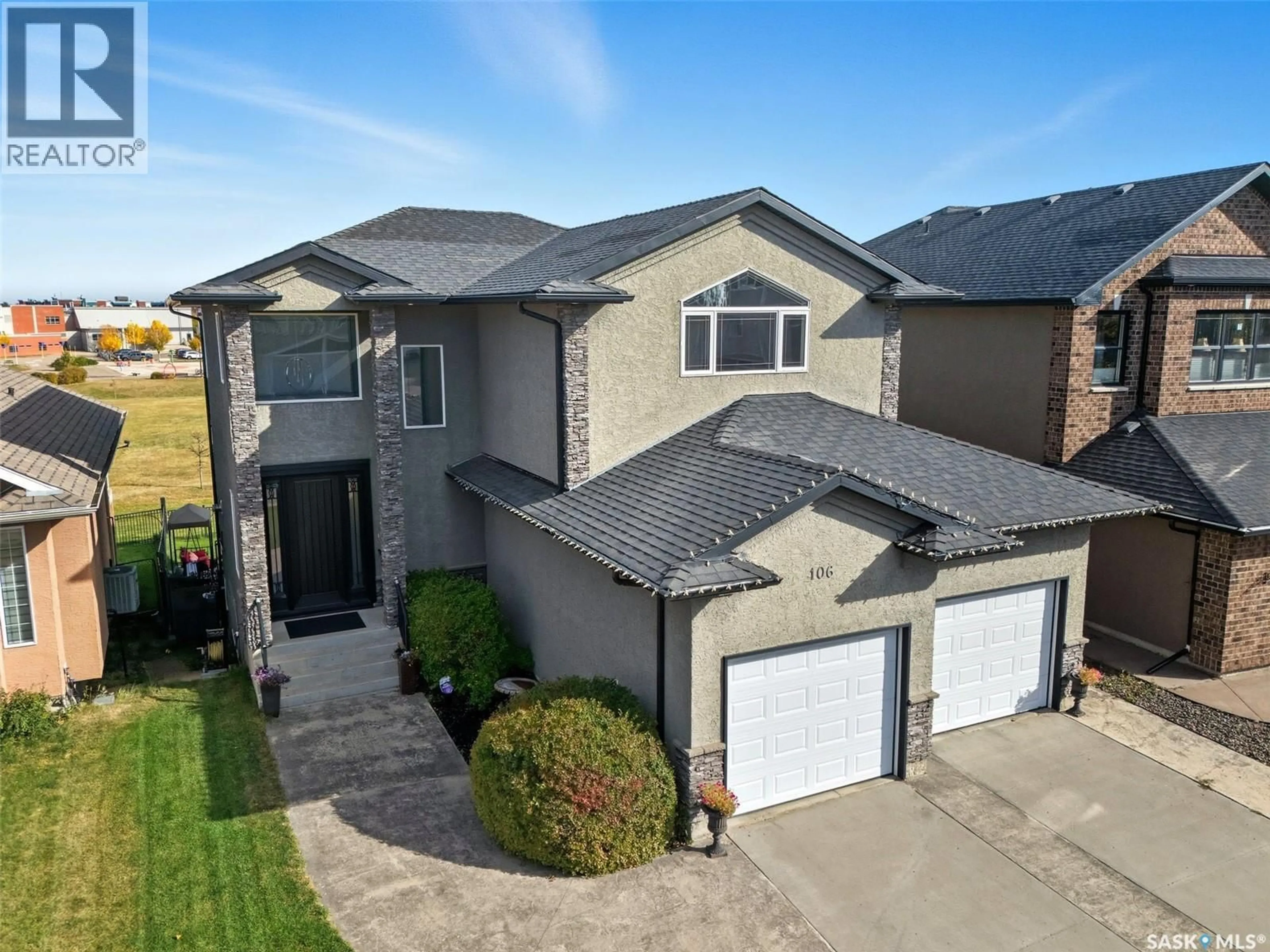 A pic from outside/outdoor area/front of a property/back of a property/a pic from drone, street for 106 THODE AVENUE, Saskatoon Saskatchewan S7W1A1