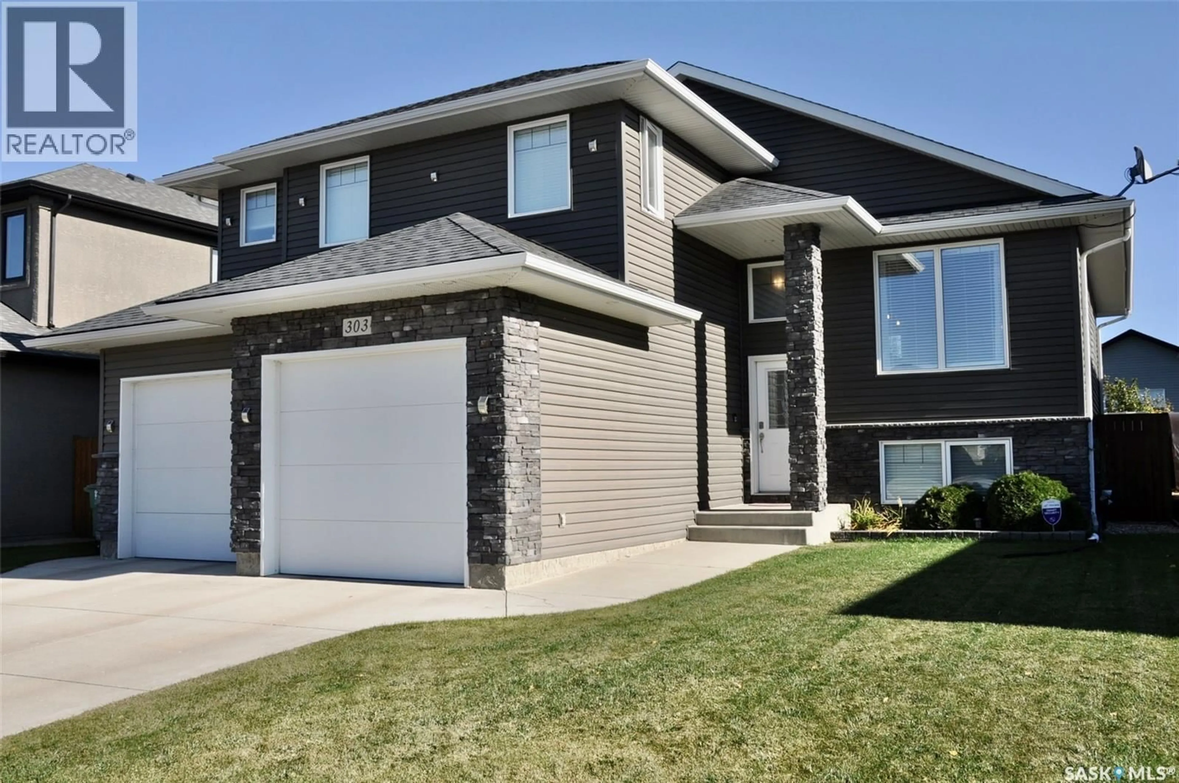 Home with vinyl exterior material, street for 303 ROY CRESCENT, Saskatoon Saskatchewan S7W0L1