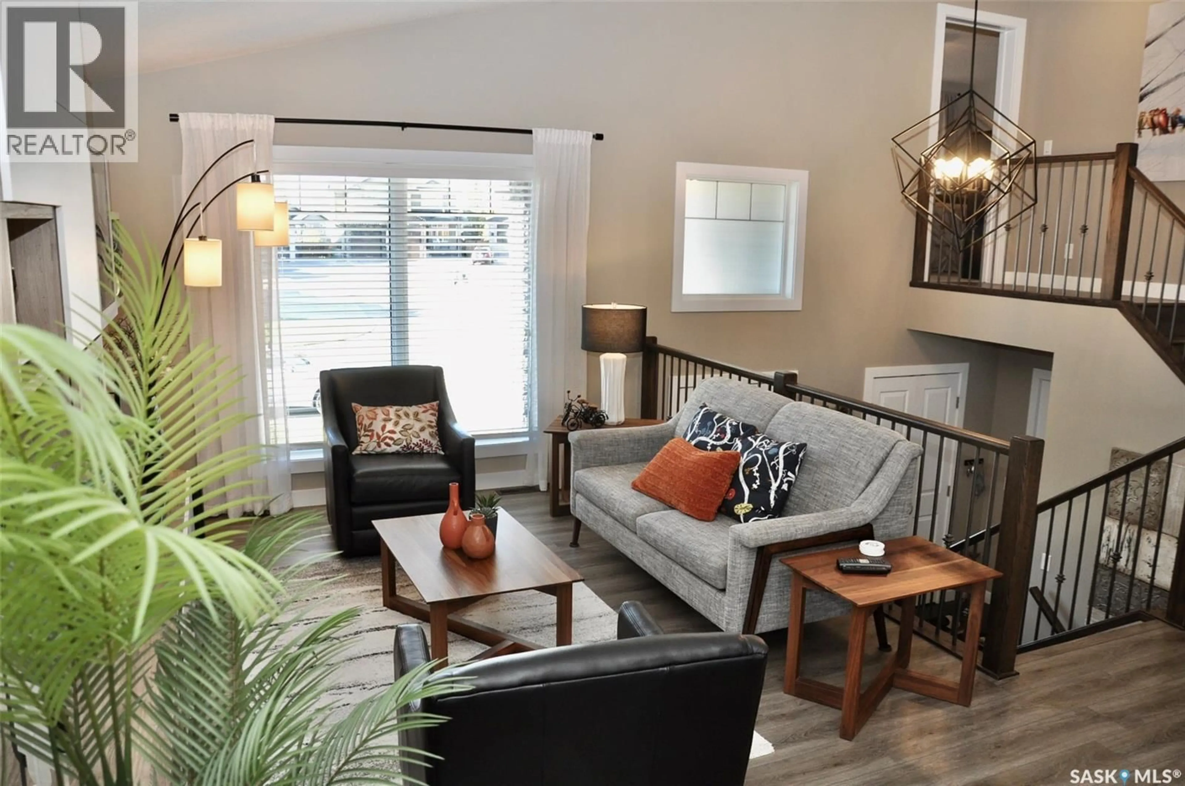 Living room with furniture, wood/laminate floor for 303 ROY CRESCENT, Saskatoon Saskatchewan S7W0L1