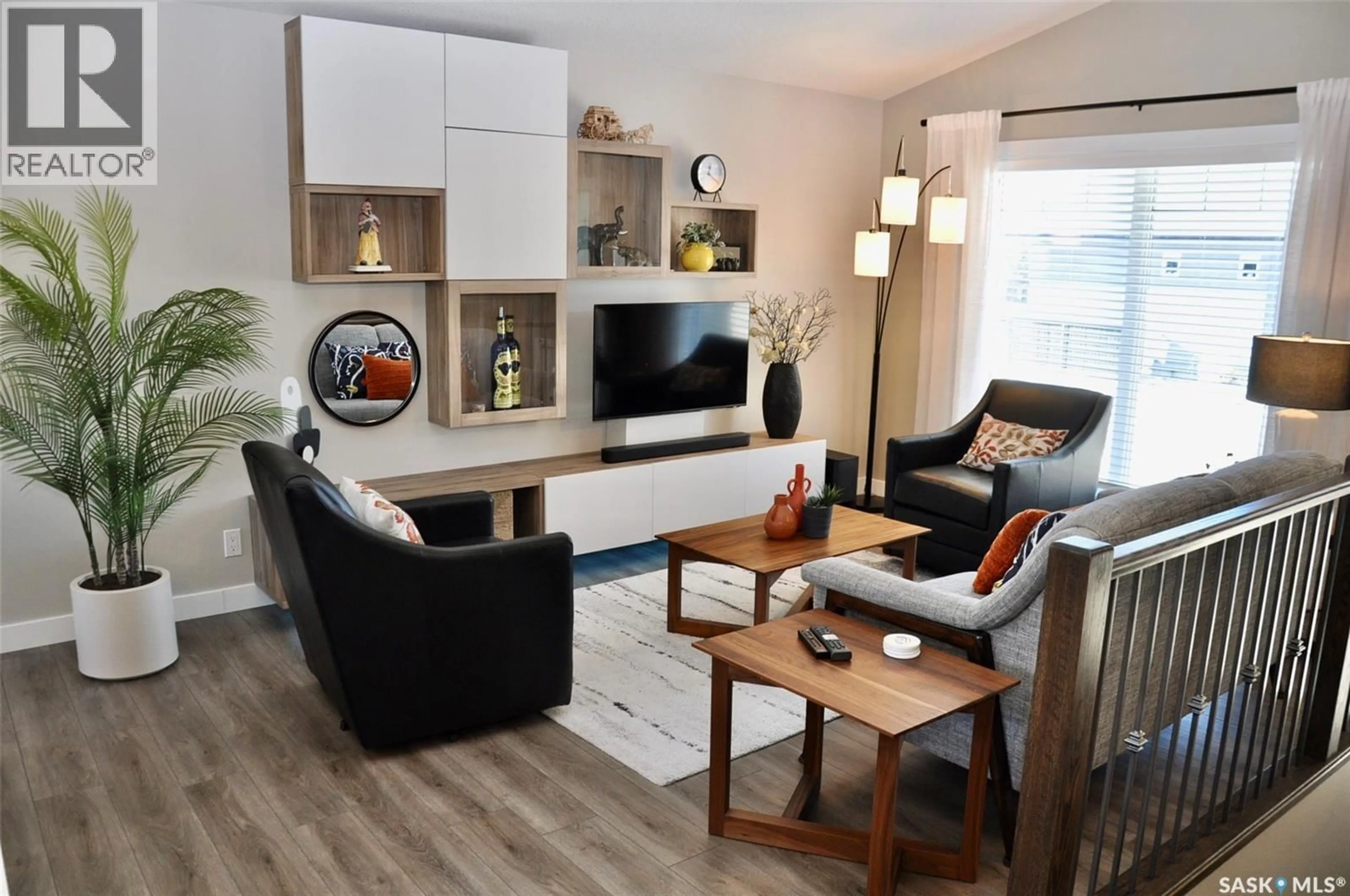 Living room with furniture, wood/laminate floor for 303 ROY CRESCENT, Saskatoon Saskatchewan S7W0L1
