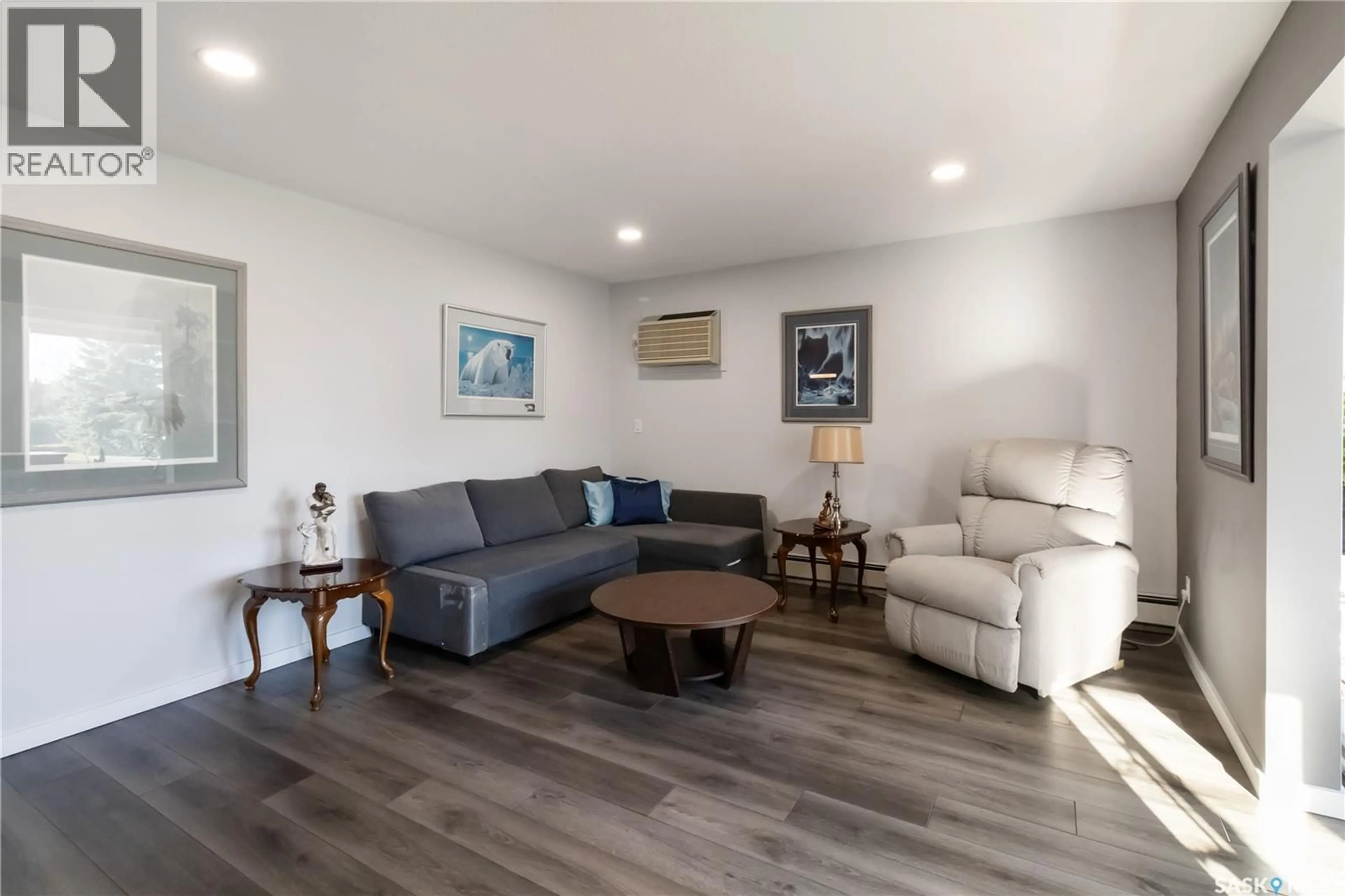 Living room with furniture, wood/laminate floor for 112 103 KEEVIL CRESCENT, Saskatoon Saskatchewan S7N4L9