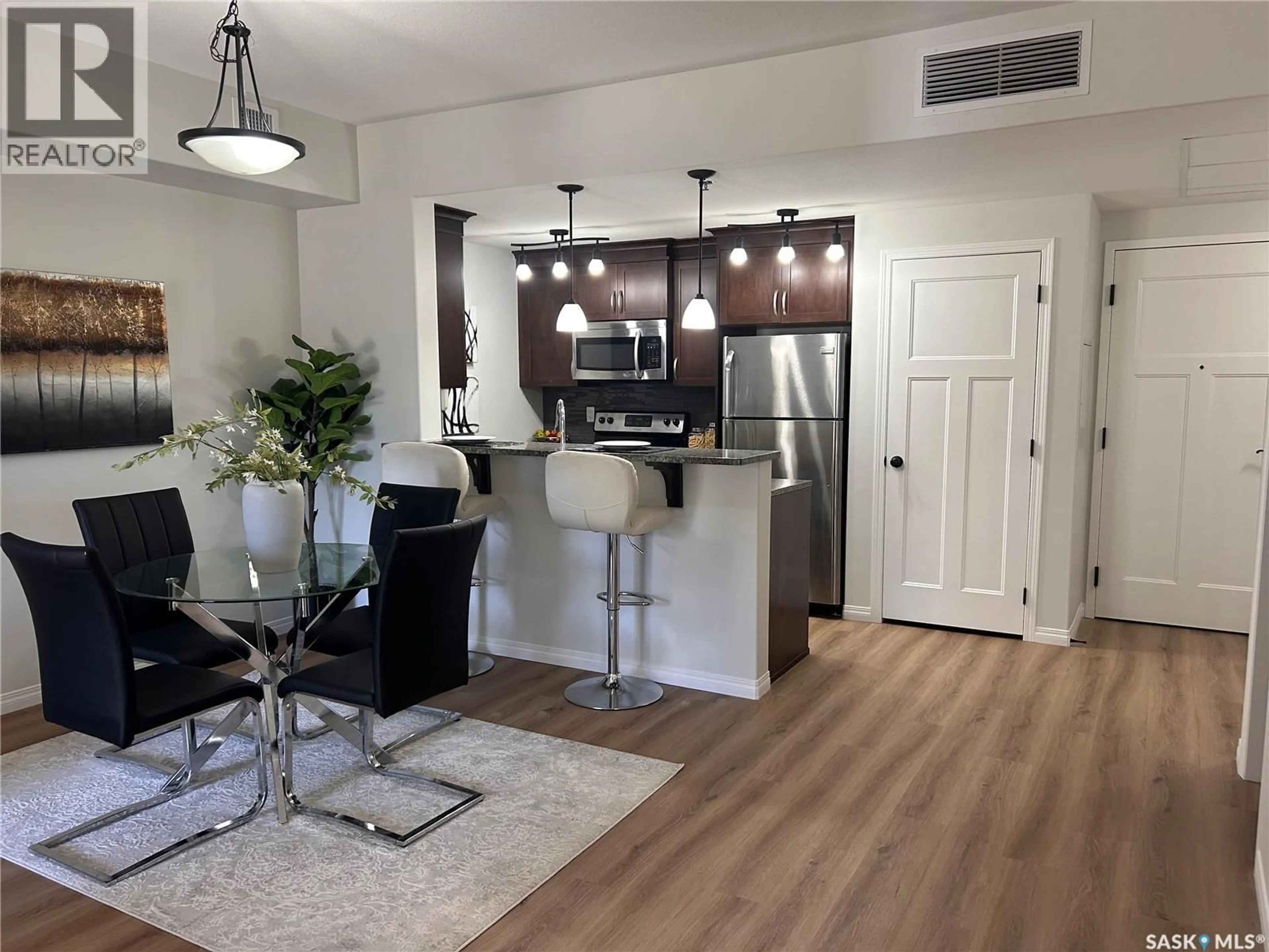 Open concept kitchen, wood/laminate floor for 117 - 1220 BLACKFOOT DRIVE, Regina Saskatchewan S4S6T2