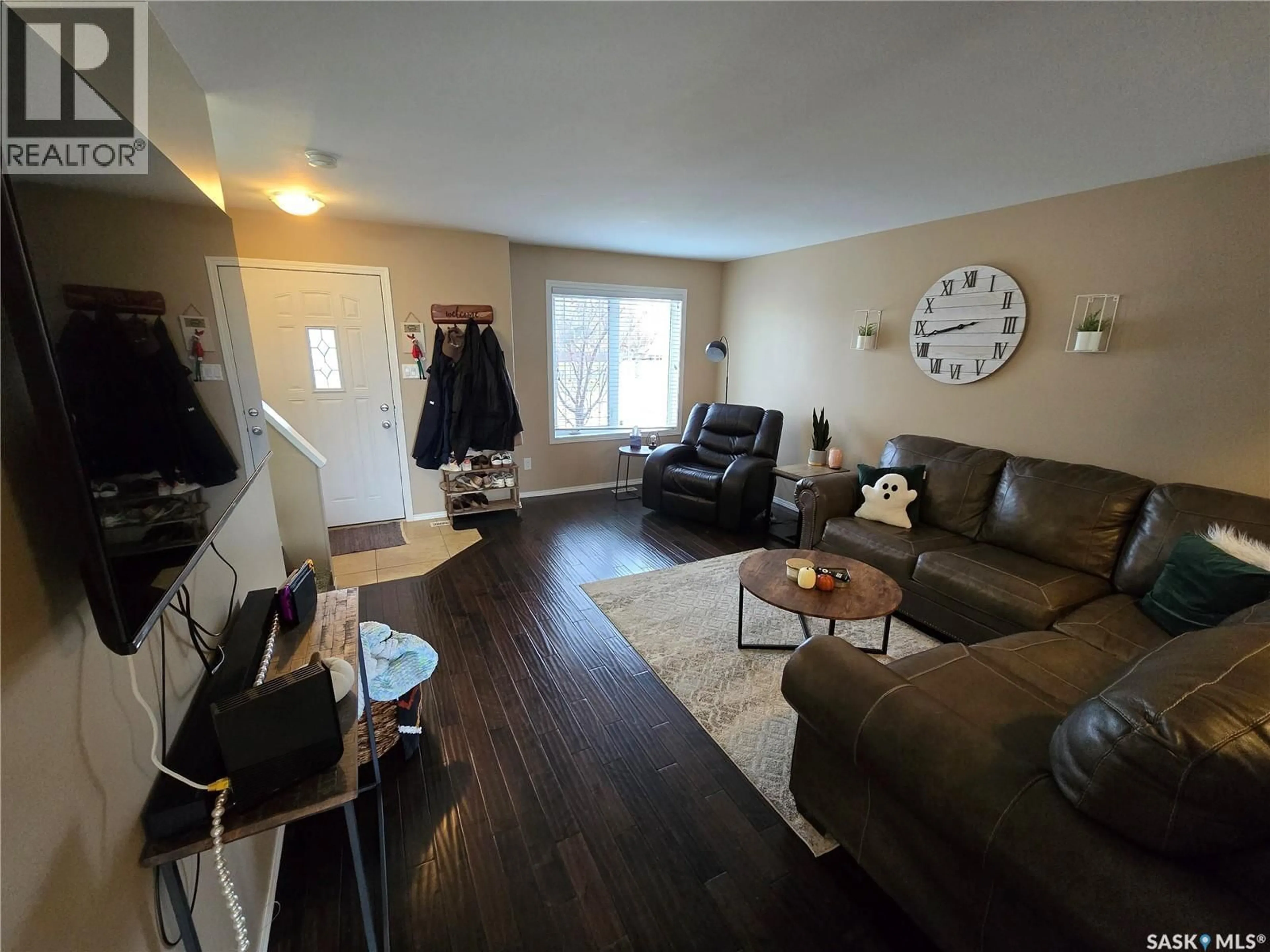 Living room with furniture, wood/laminate floor for NE - 6 815 5TH STREET, Weyburn Saskatchewan S4H2K9