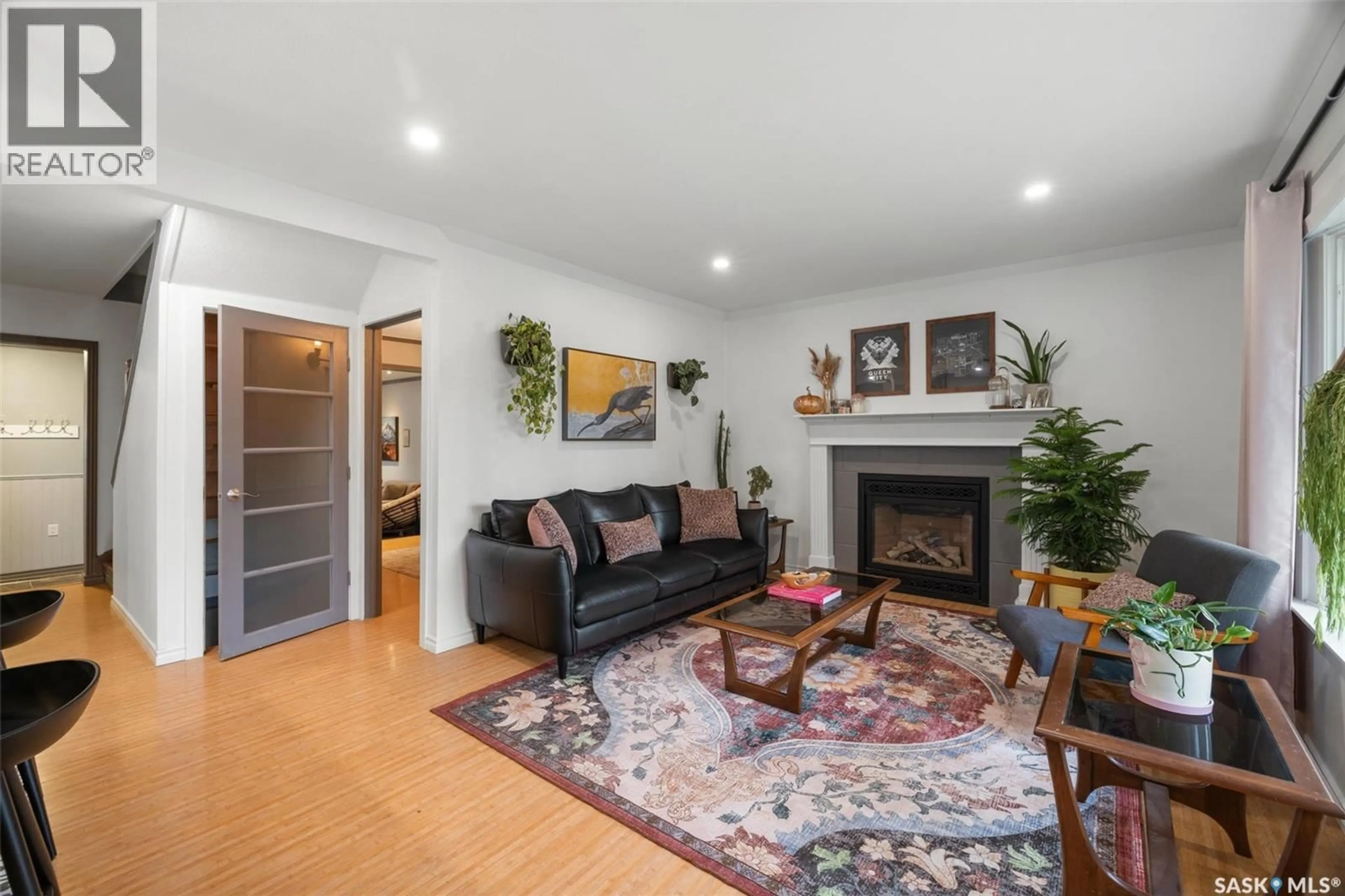 Living room with furniture, wood/laminate floor for 2808 MONTAGUE STREET, Regina Saskatchewan S4S1Z2