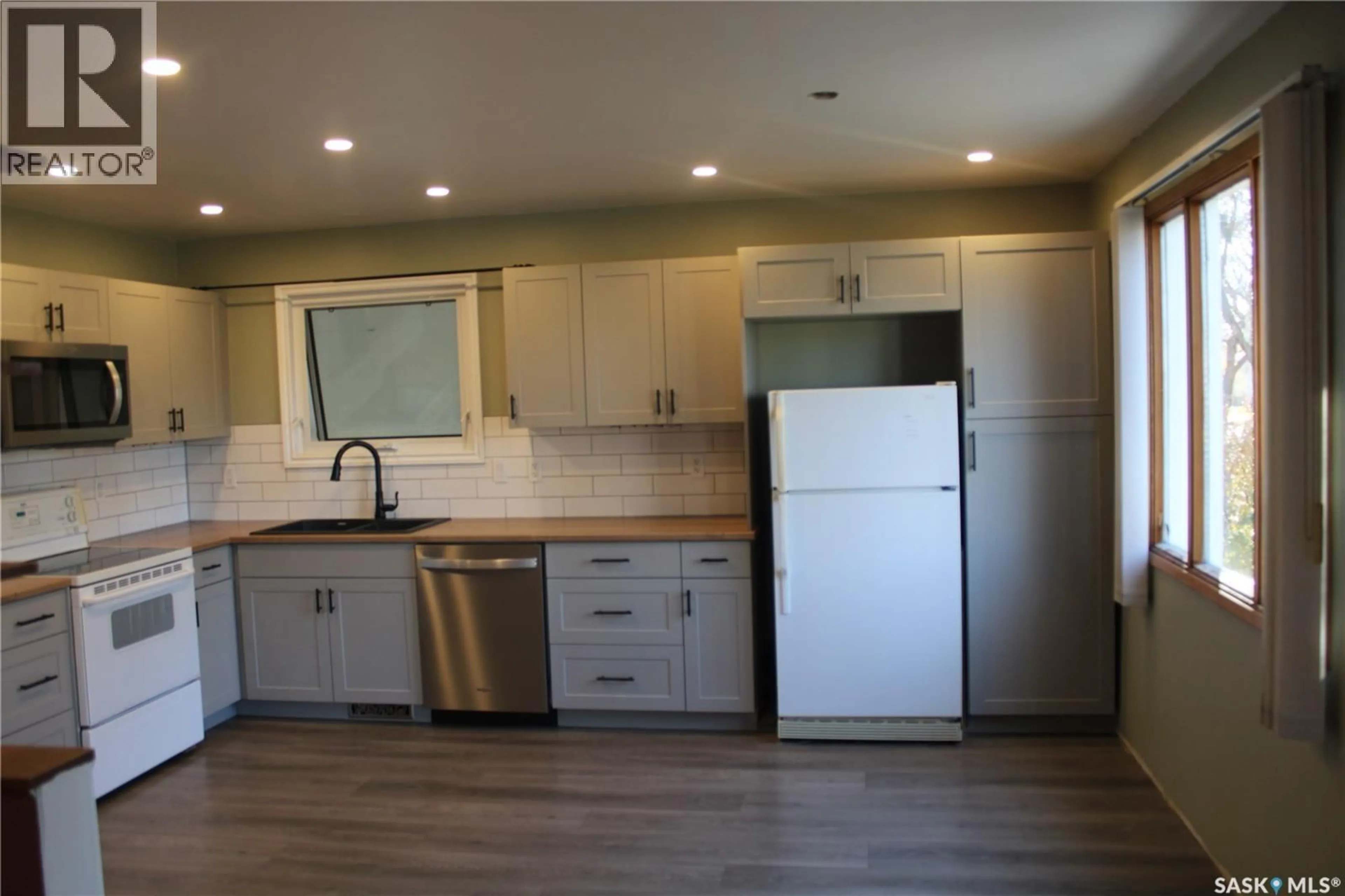 Open concept kitchen, wood/laminate floor for 103 WELLINGTON AVENUE, Yorkton Saskatchewan S3N1Y1