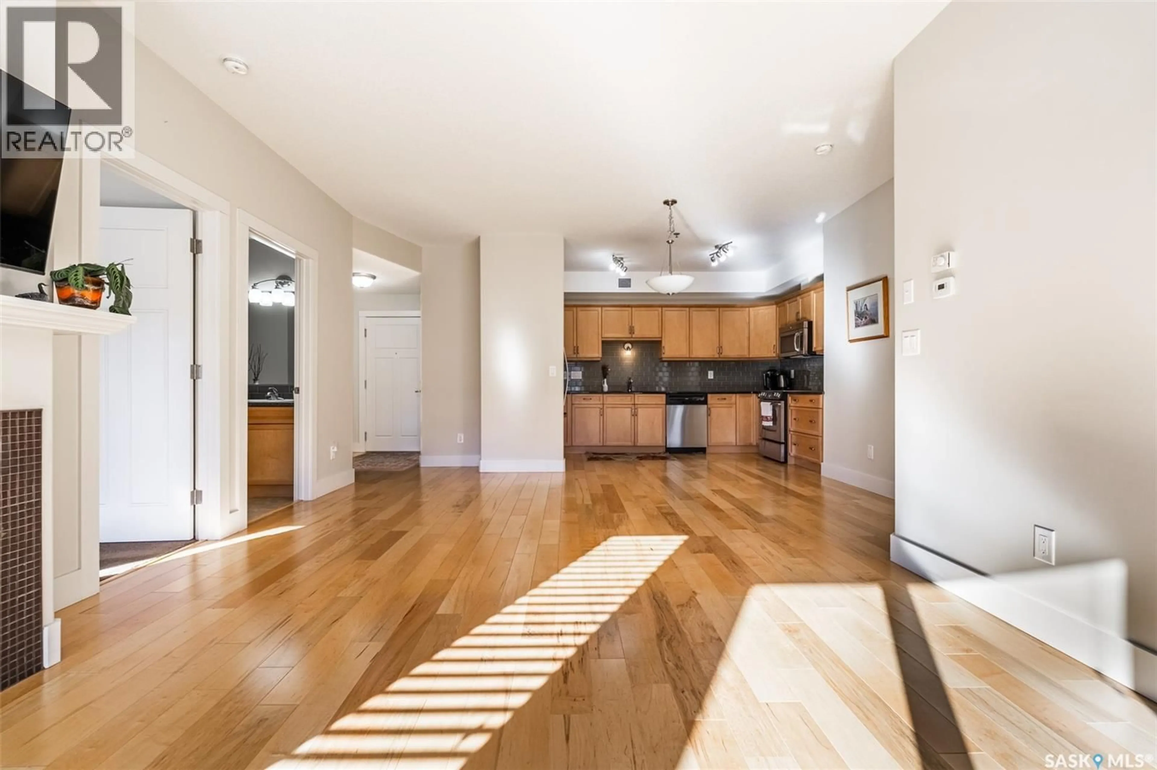 Open concept kitchen, wood/laminate floor for 207 - 1010 RUTH STREET, Saskatoon Saskatchewan S7J4M9