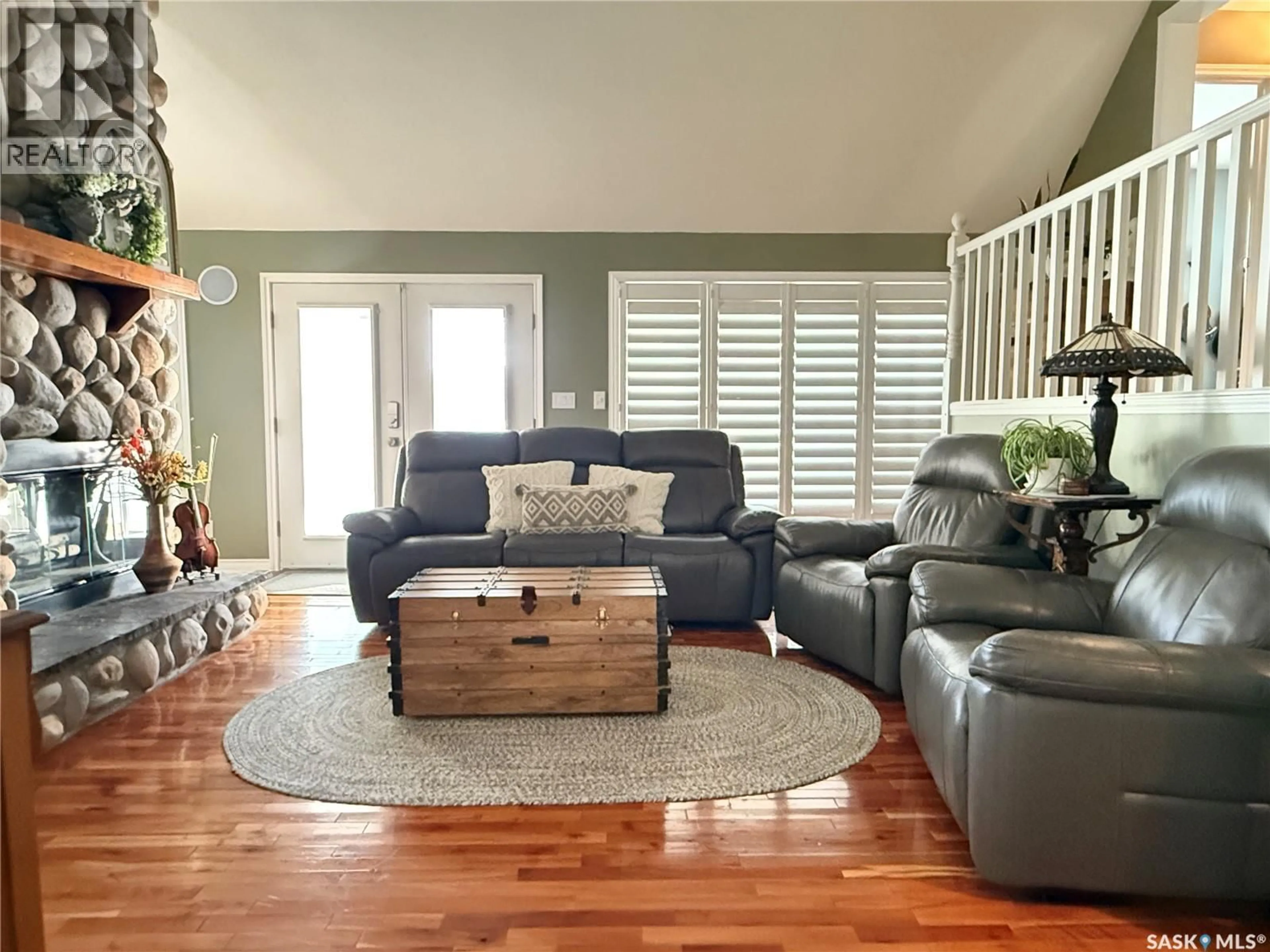 Living room with furniture, wood/laminate floor for 18 LAKEVIEW LANE, Melville Beach Saskatchewan S0A1E0