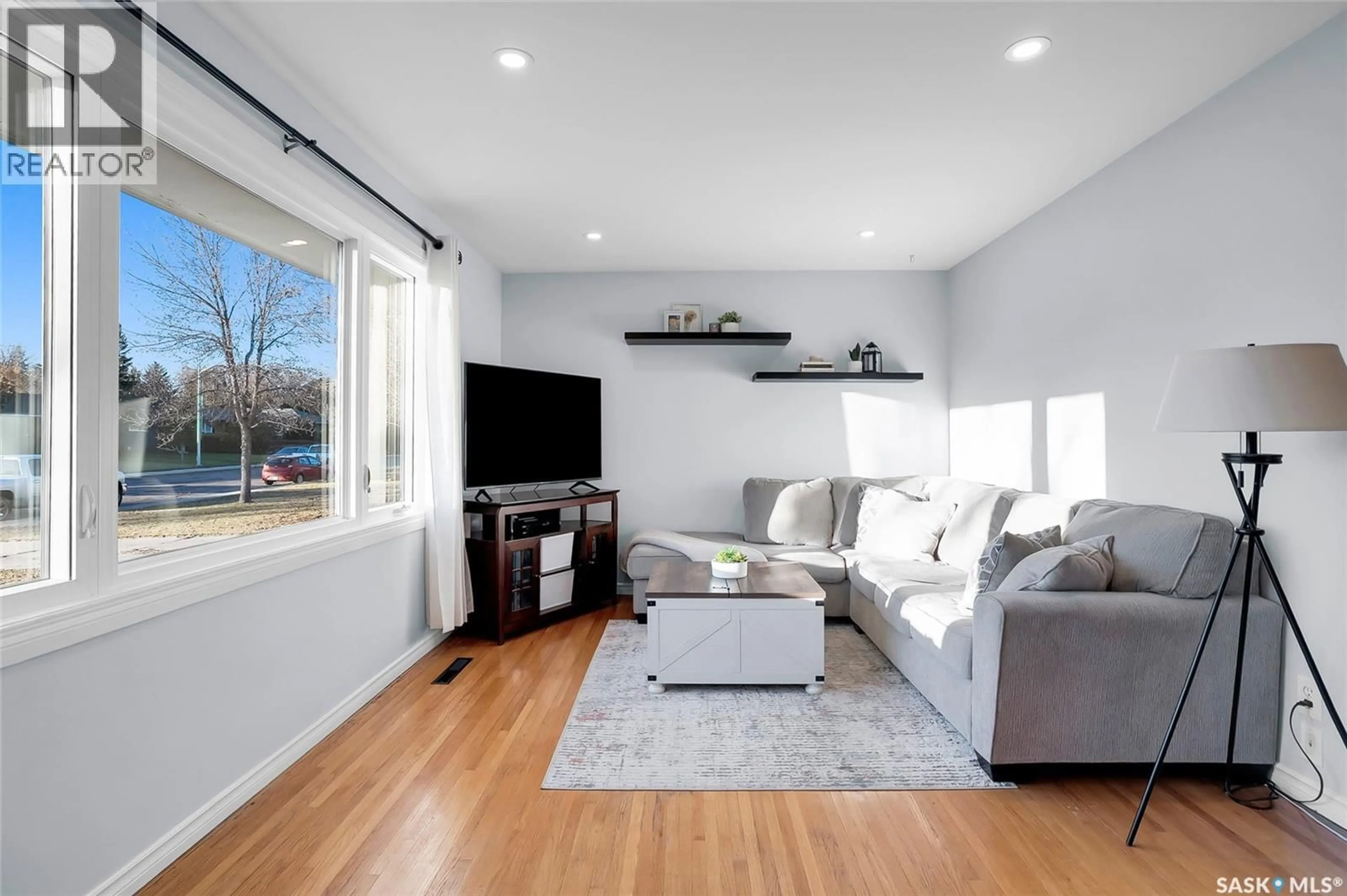 Living room with furniture, wood/laminate floor for 2221 HAULTAIN AVENUE, Saskatoon Saskatchewan S7J1P7