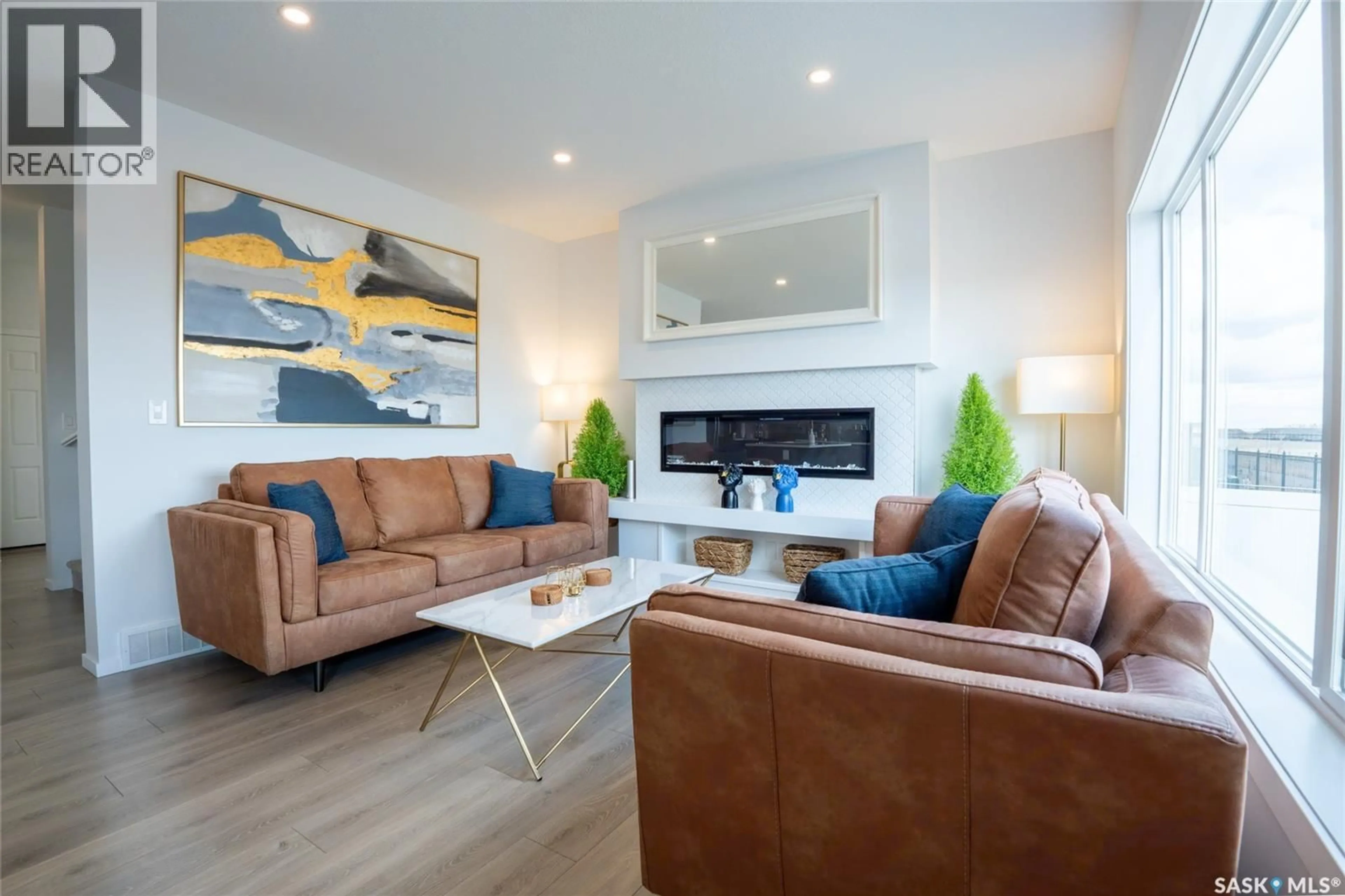 Living room with furniture, wood/laminate floor for 3033 BELLEGARDE CRESCENT, Regina Saskatchewan S4V3W3