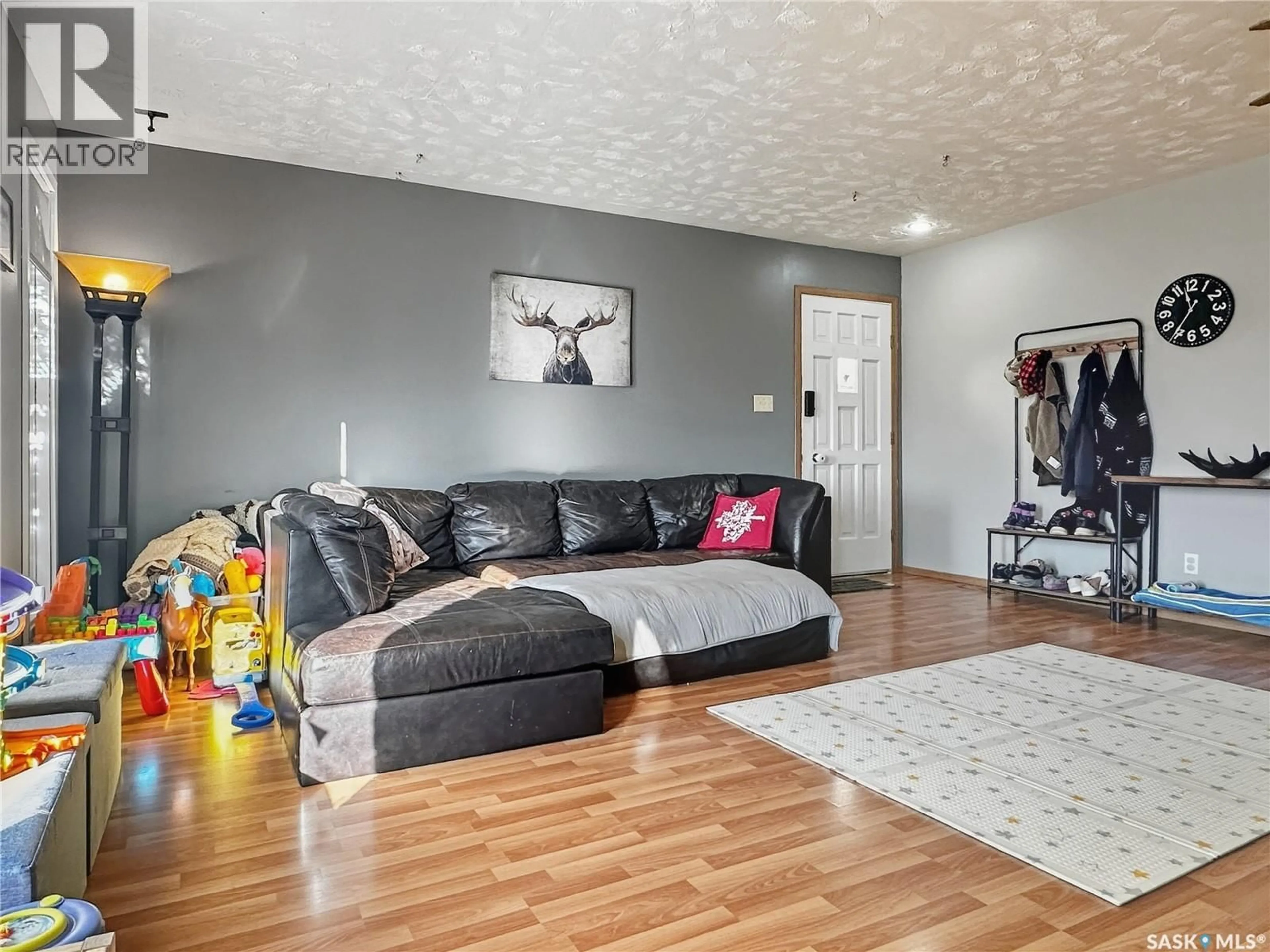 Living room with furniture, wood/laminate floor for 2168 DOUGLAS AVENUE, North Battleford Saskatchewan S9A3A9