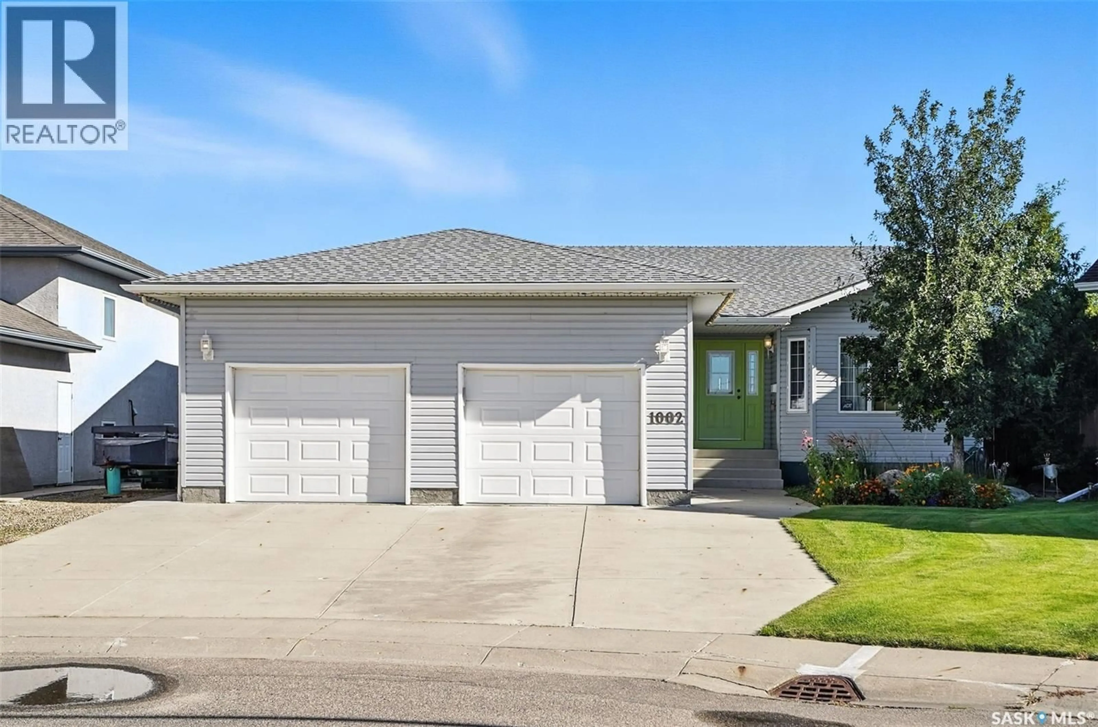 Home with vinyl exterior material, street for 1002 CARR CRESCENT, Saskatoon Saskatchewan S7S1L9