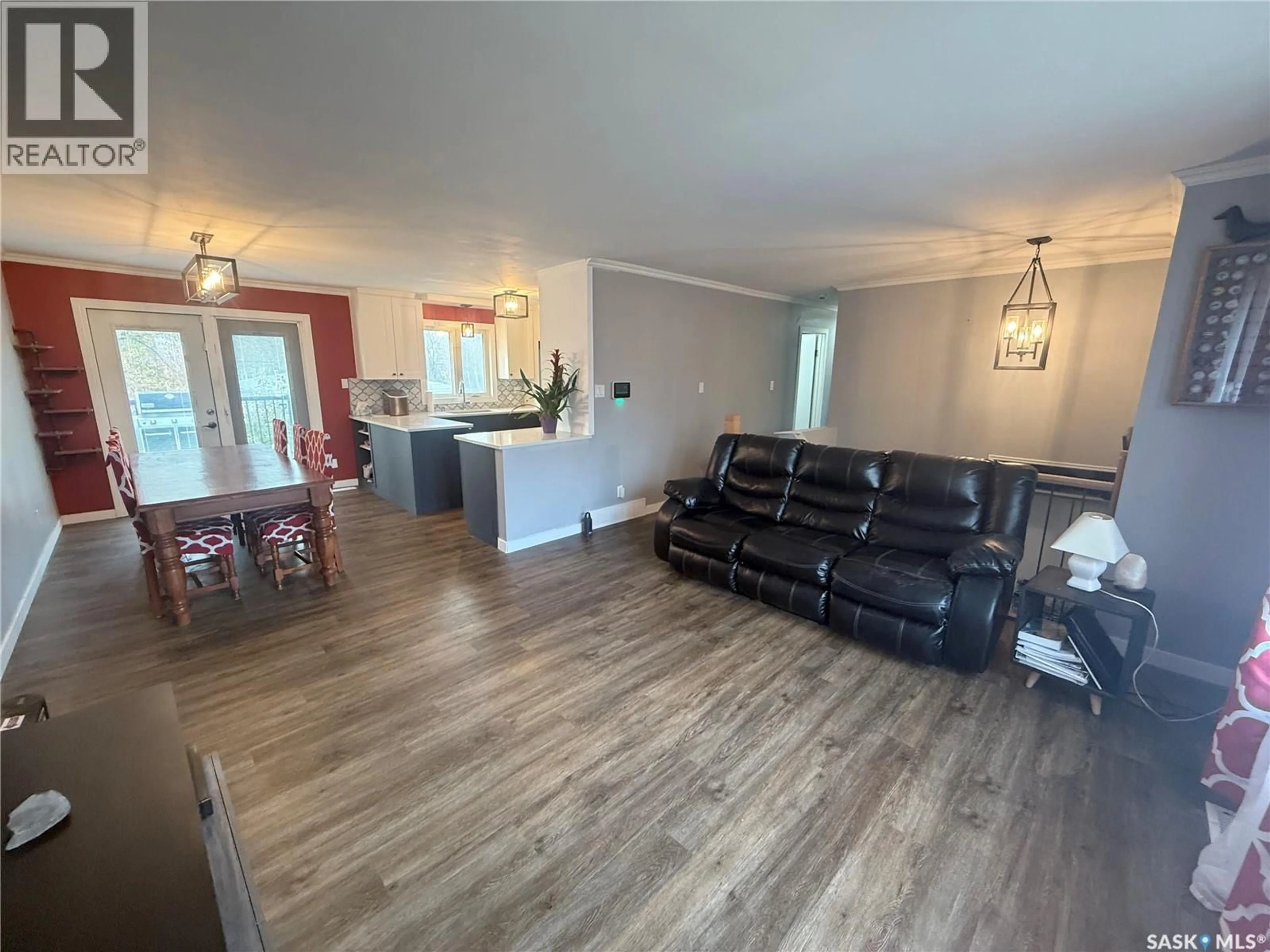 Living room with furniture, wood/laminate floor for 607 CLOVER AVENUE, Dalmeny Saskatchewan S0K1E0