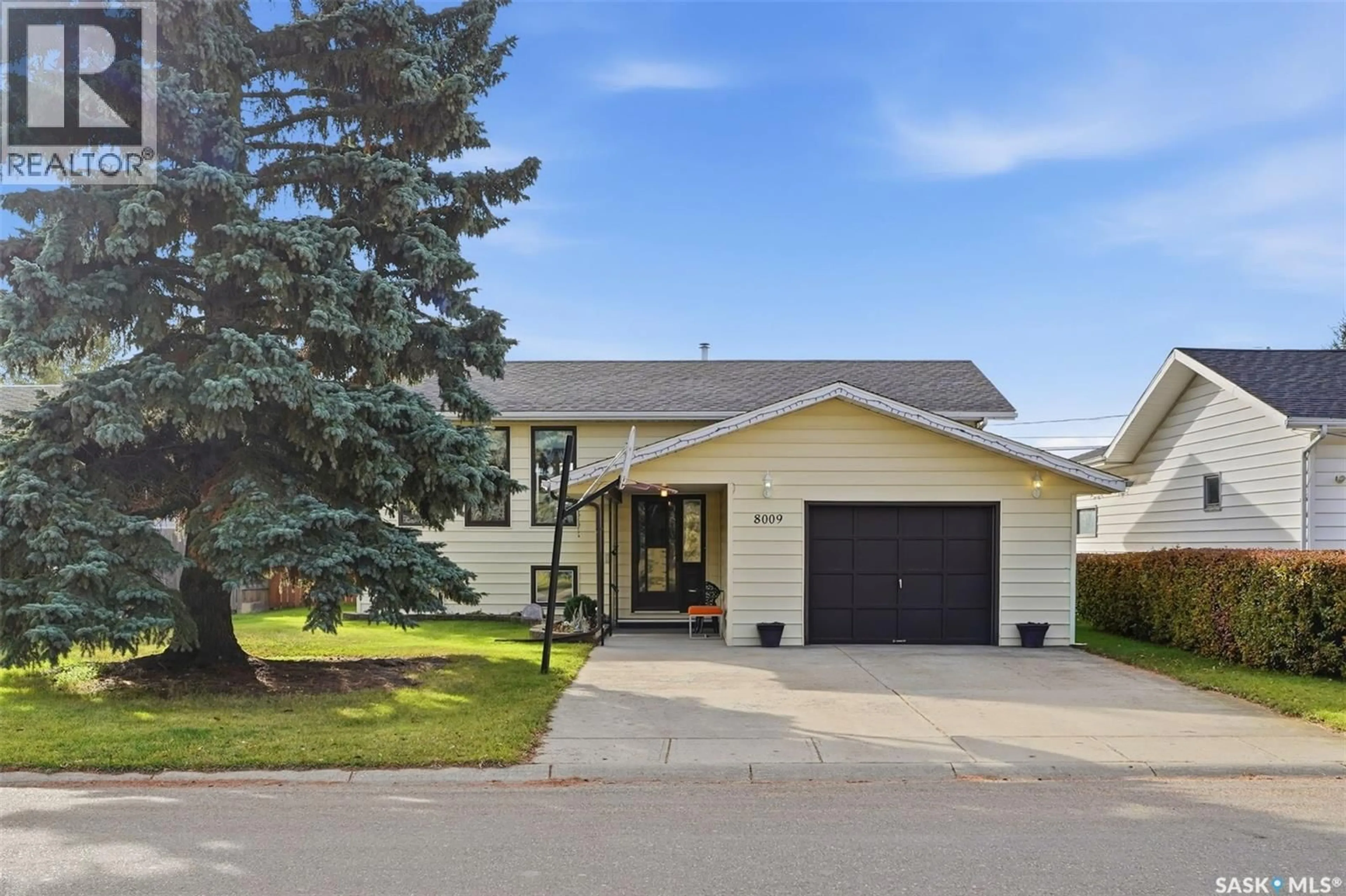 Home with vinyl exterior material, street for 8009 5TH STREET, Rosthern Saskatchewan S0K3R0