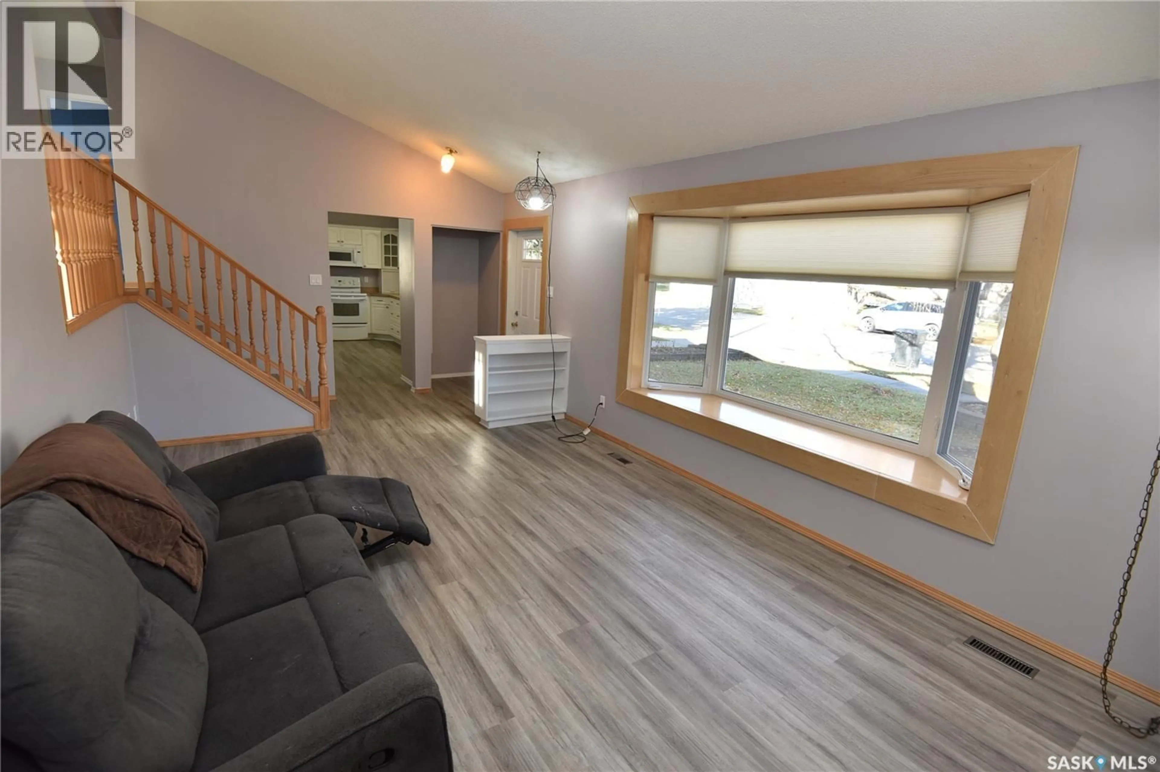 Living room with furniture, wood/laminate floor for 1211 1ST STREET, Nipawin Saskatchewan S0E1E0