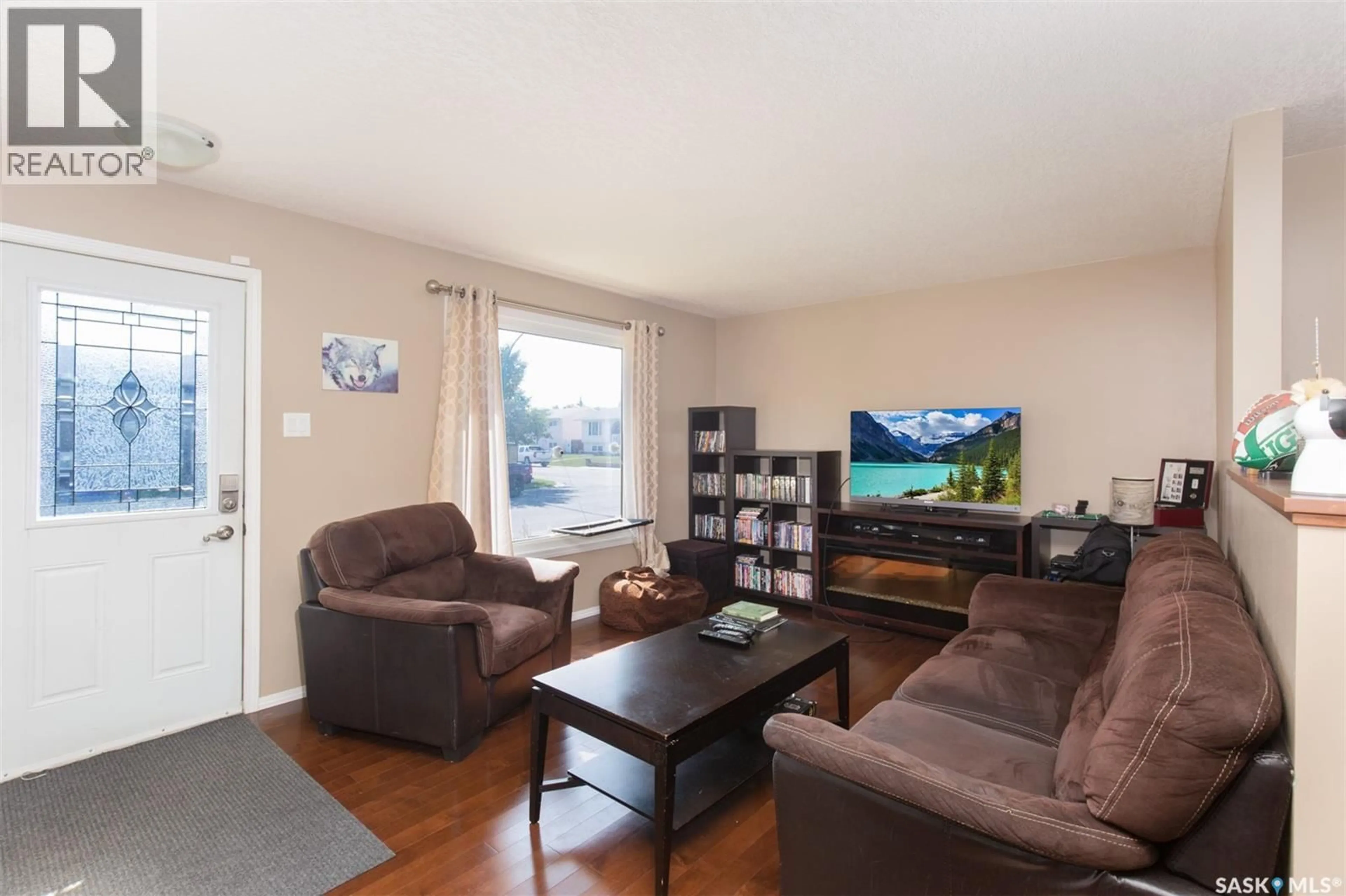 Living room with furniture, wood/laminate floor for 1443 SIOUX CRESCENT, Moose Jaw Saskatchewan S6H7C8
