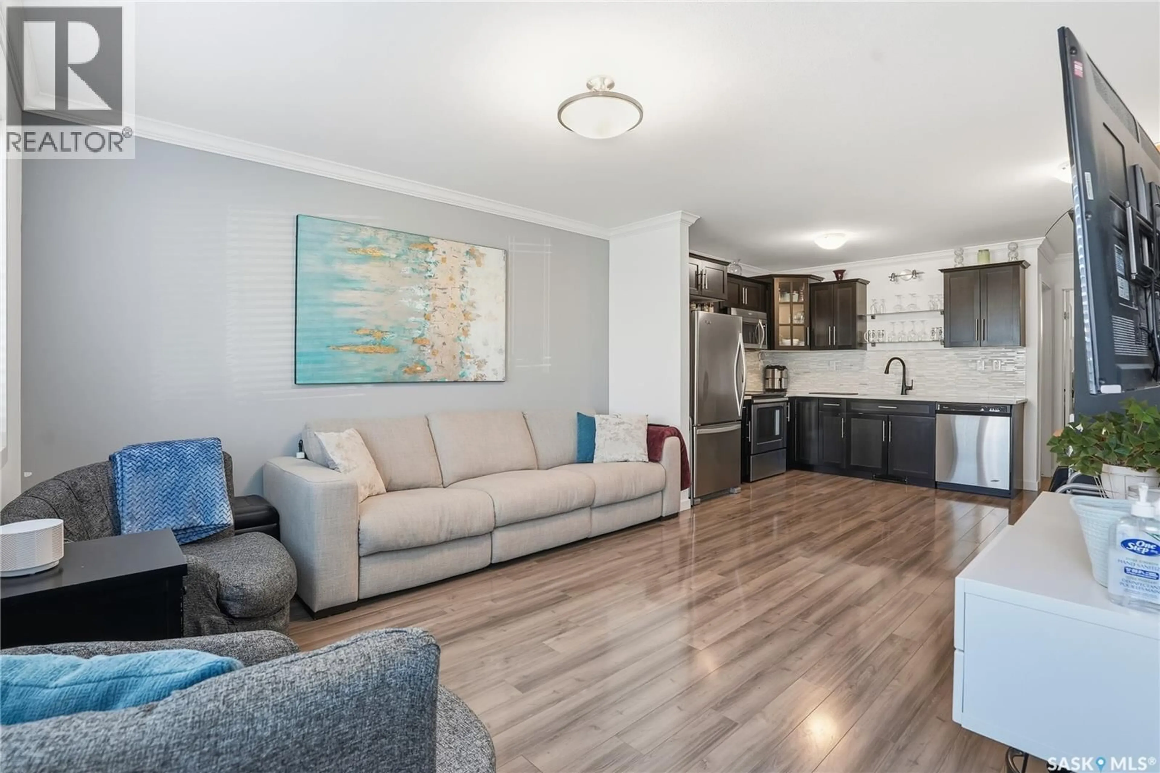 Living room with furniture, wood/laminate floor for 250 - 258 AKHTAR BEND, Saskatoon Saskatchewan S7W0W4