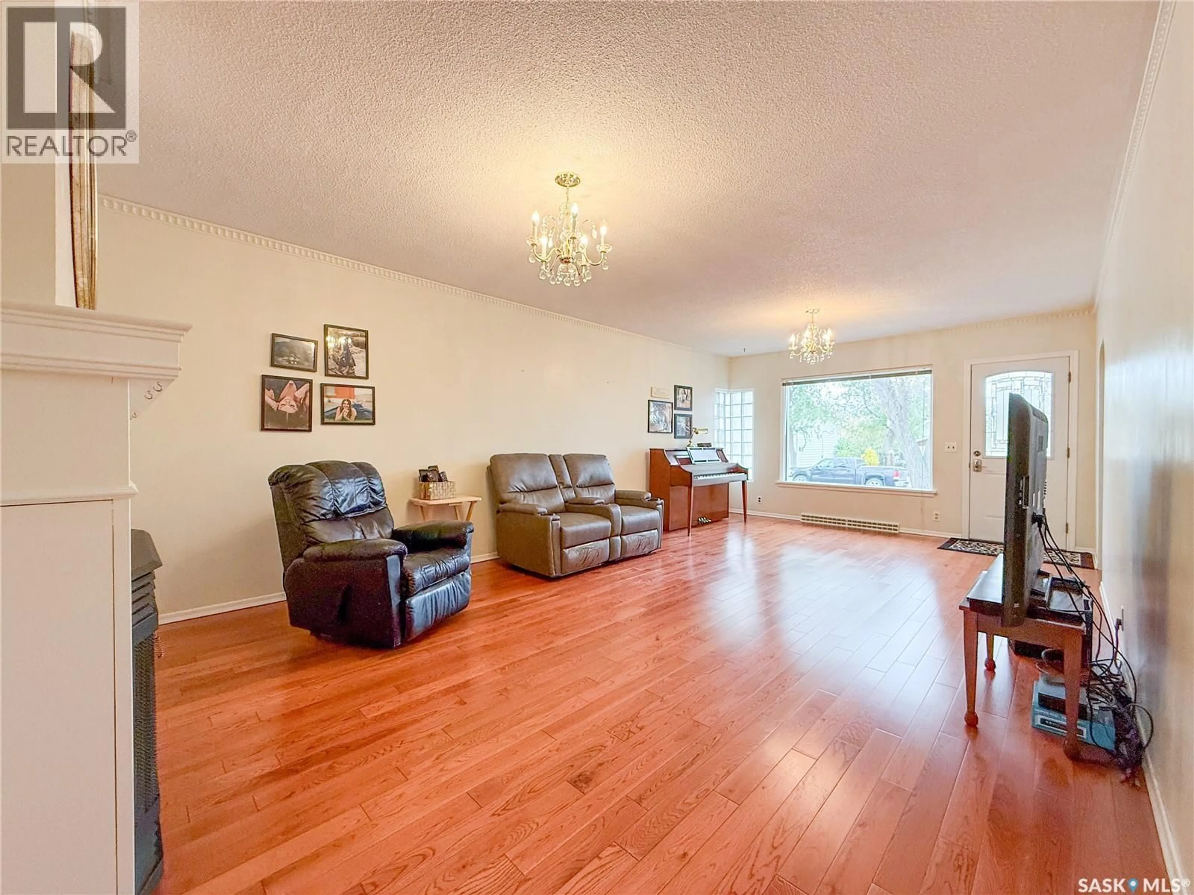 Living room with furniture, wood/laminate floor for 220 1ST STREET, Ponteix Saskatchewan S0N1Z0